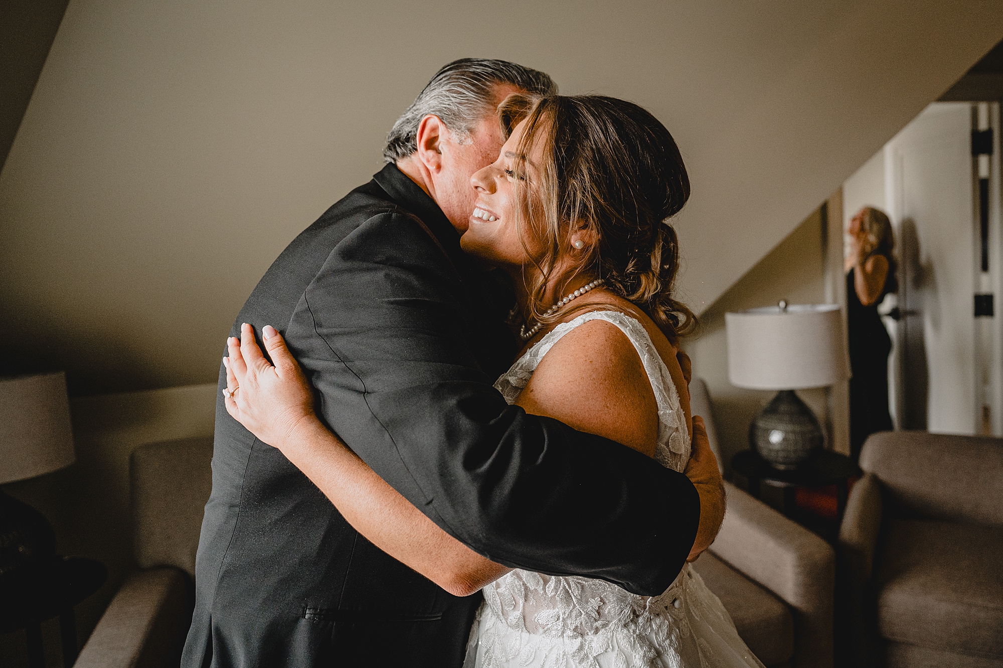 bride and dad hug during first look on wedding day 