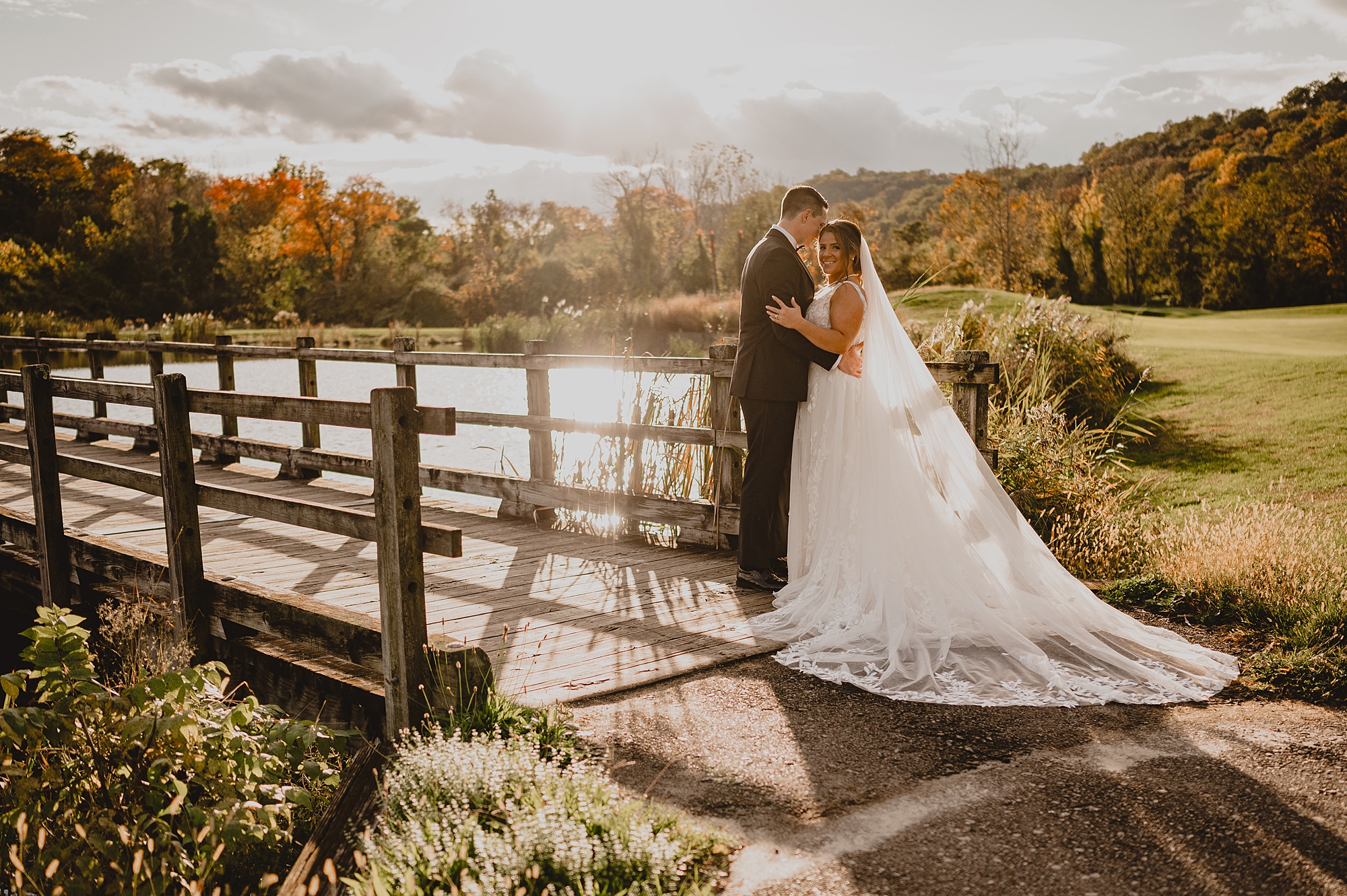 bride and groom kiss at sunset at Hollow Brook Golf Club
