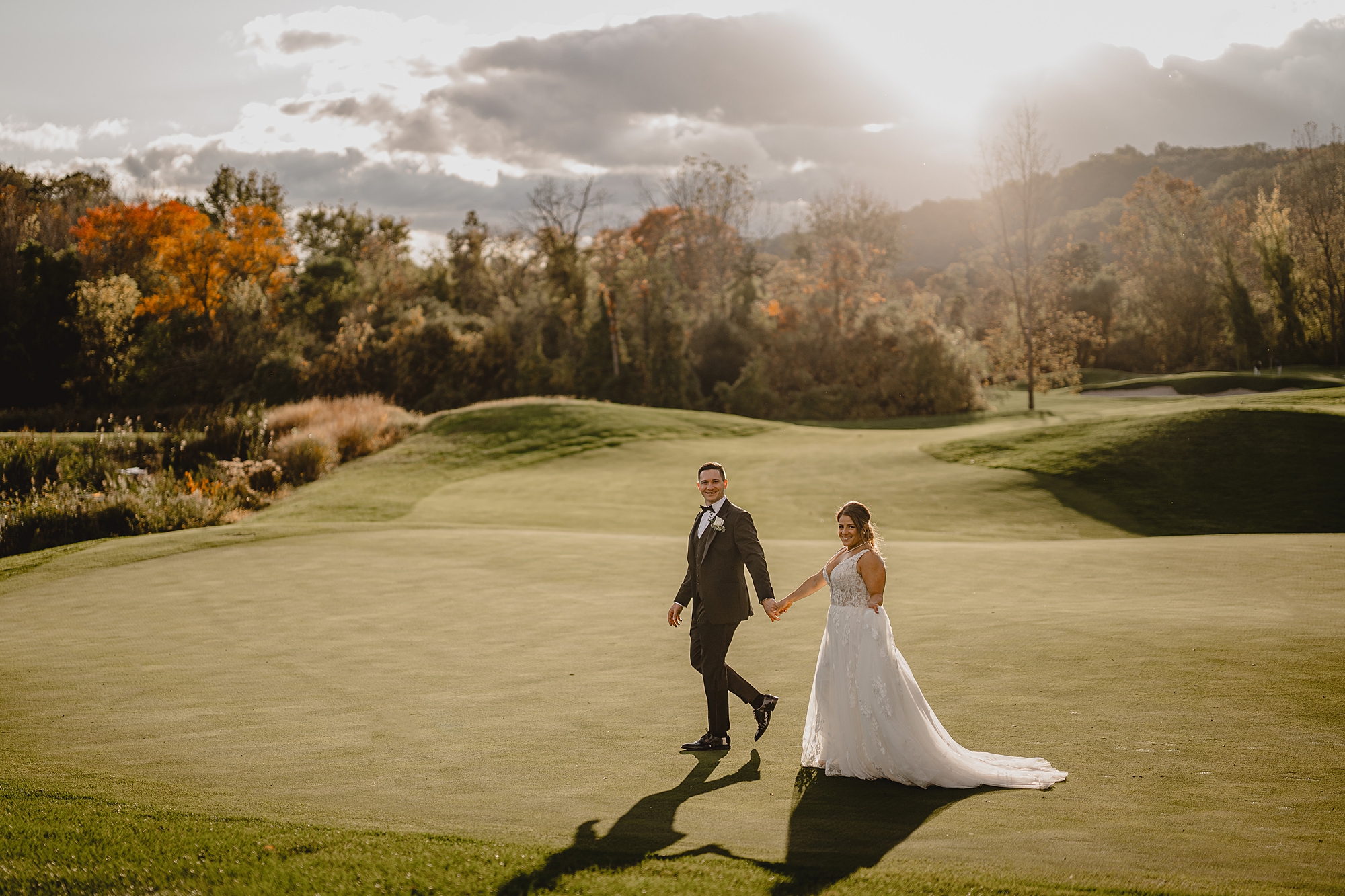 far away photo of couple walking on putting green 