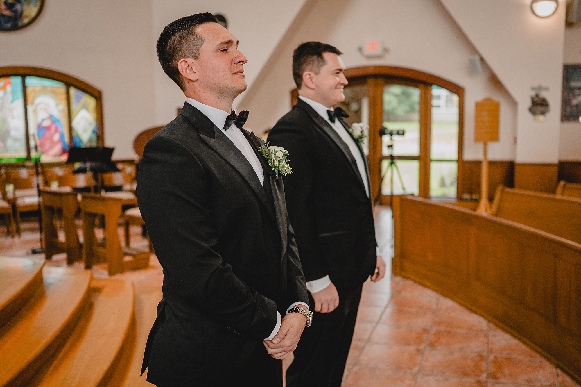 groom looks at guests in church 