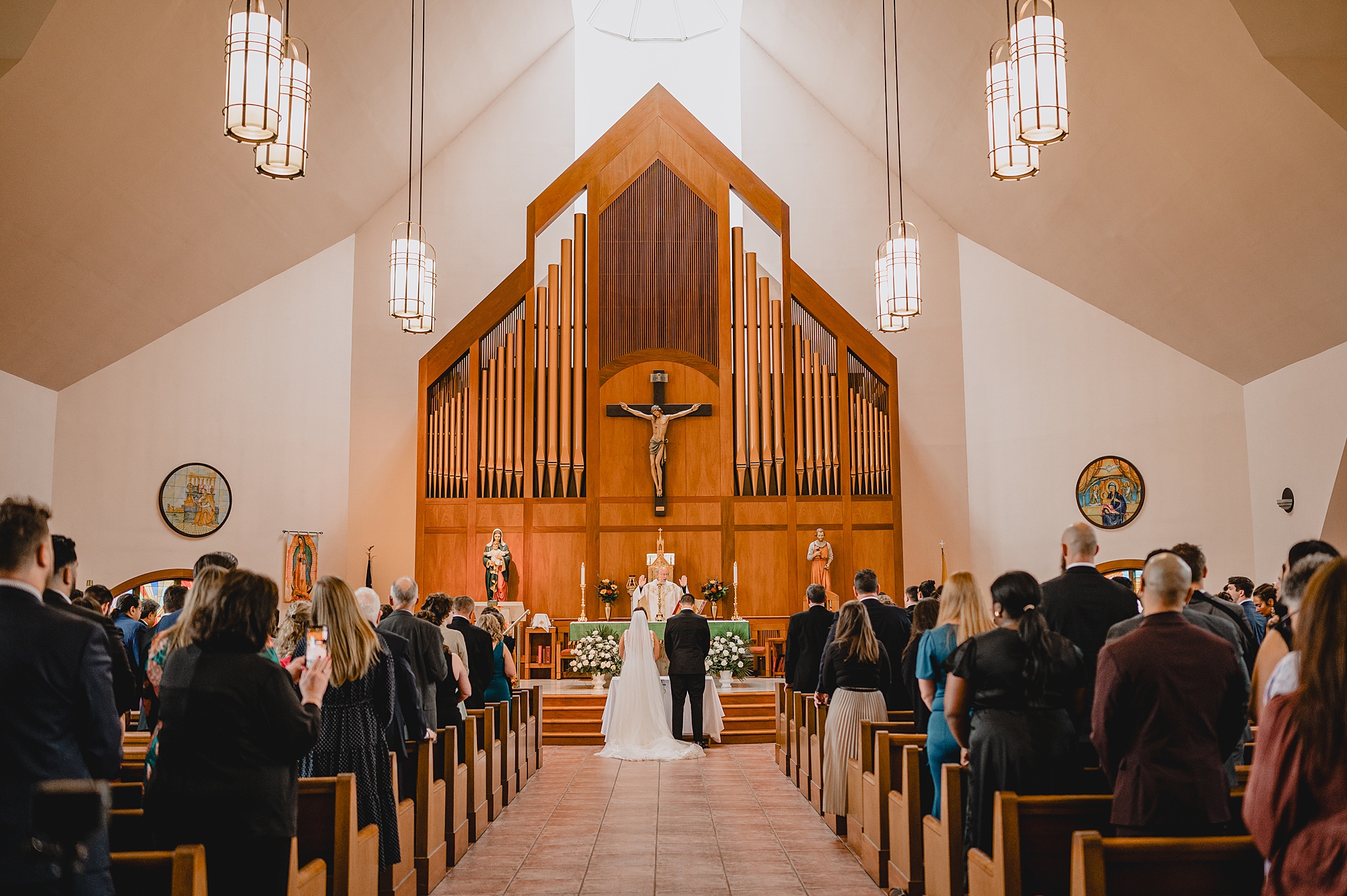 bride and groom stand at altar during traditional church ceremony in New York