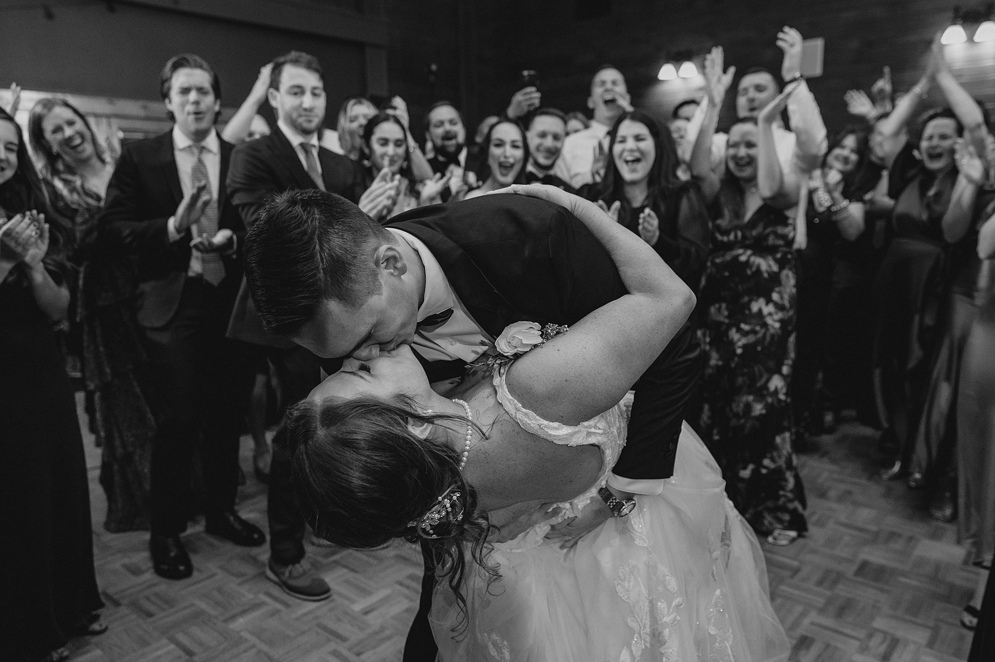 groom kisses bride dipping her at Hollow Brook Golf Club