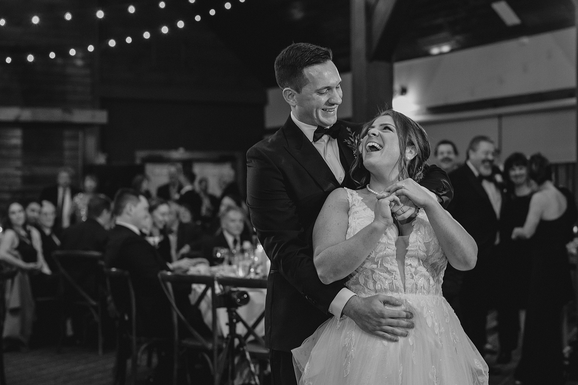 groom hugs bride from behind on dance floor at Cortlandt, NY reception