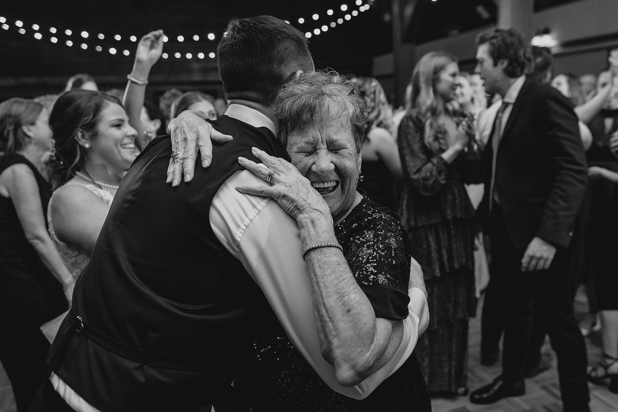 wedding guests dance with groom during Cortlandt, NY reception