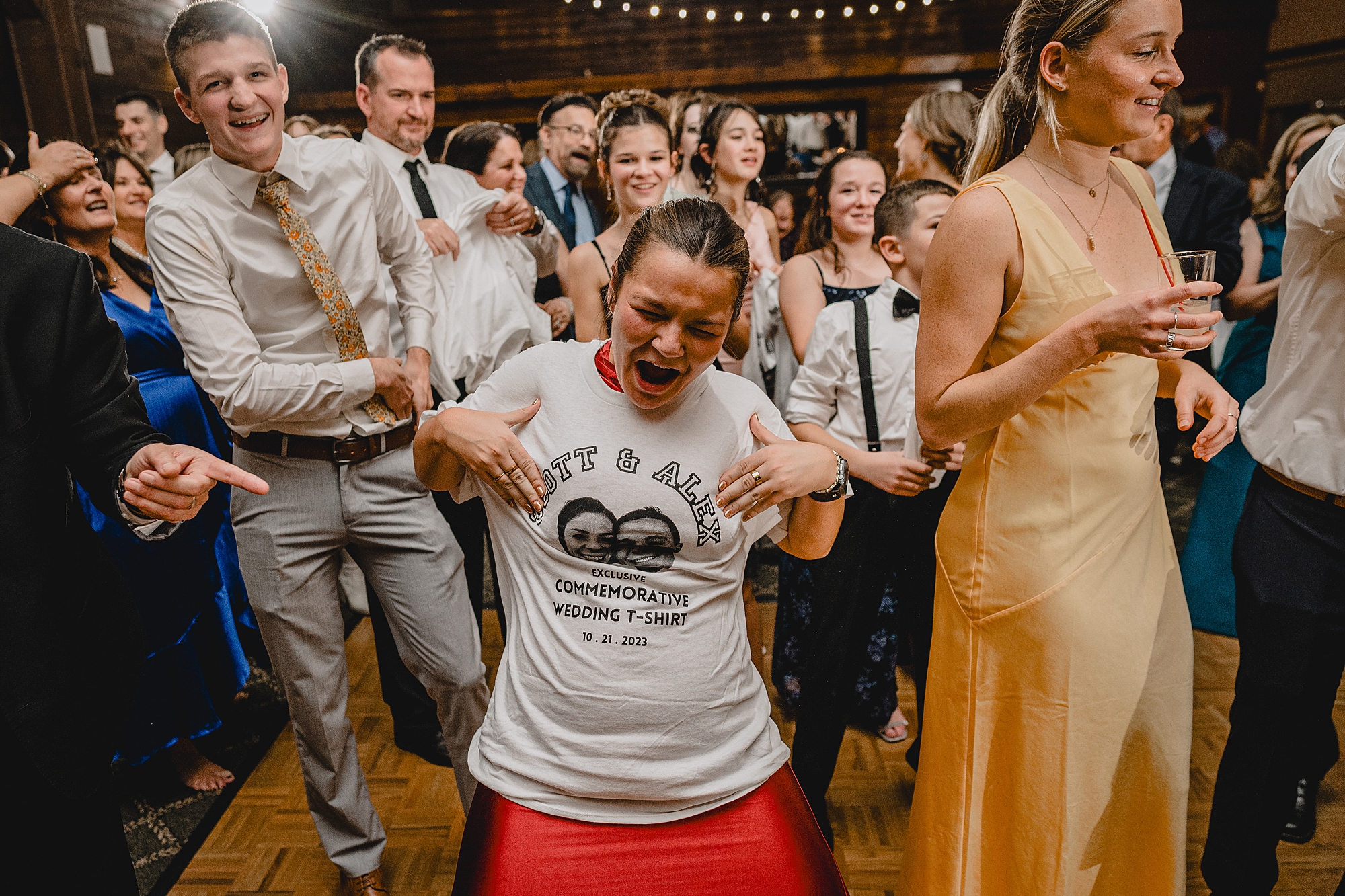 wedding guest dances in custom commemorative t-shirt during Cortlandt, NY reception