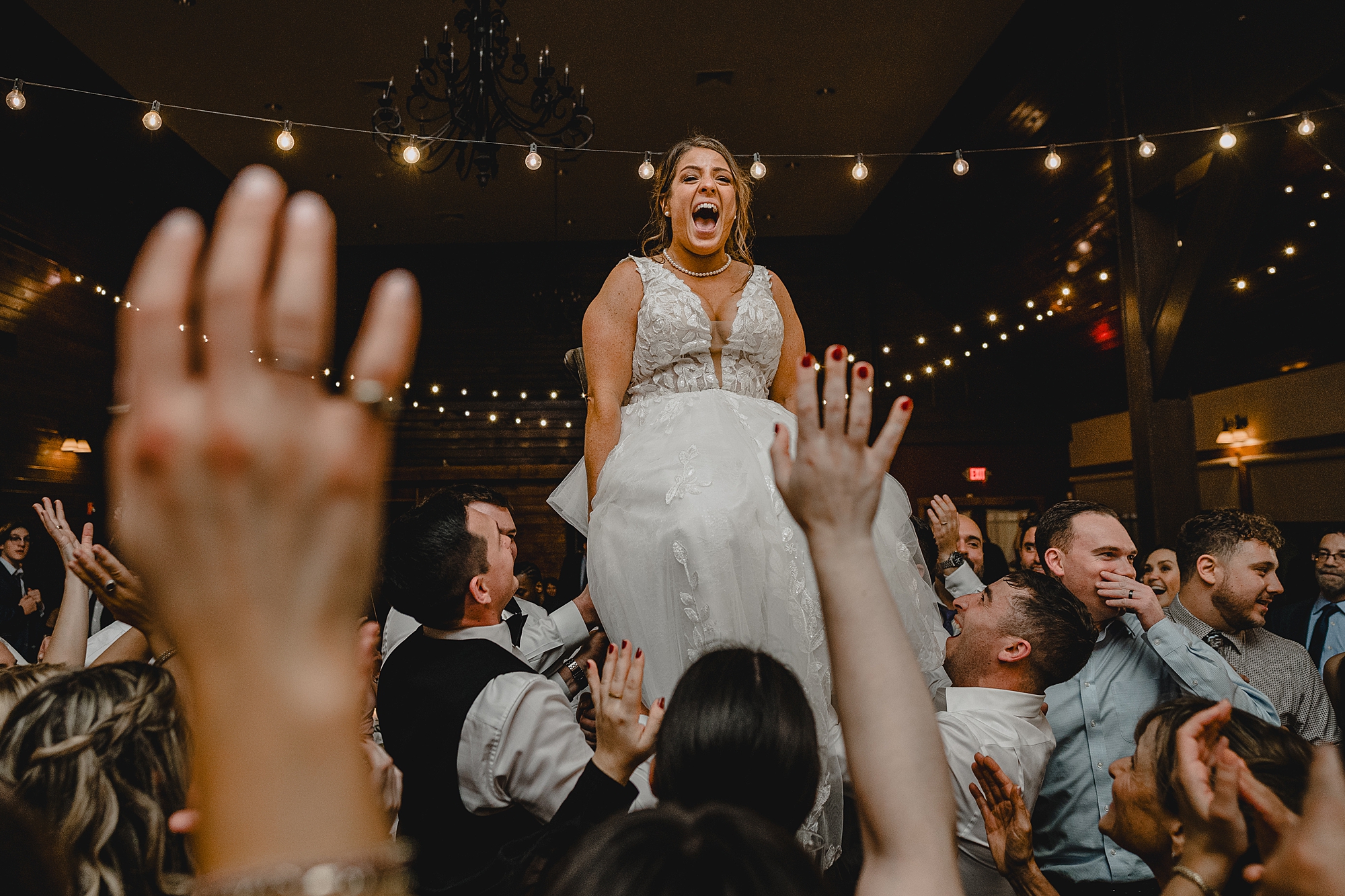 wedding guests dance lifting up bride during Cortlandt, NY reception