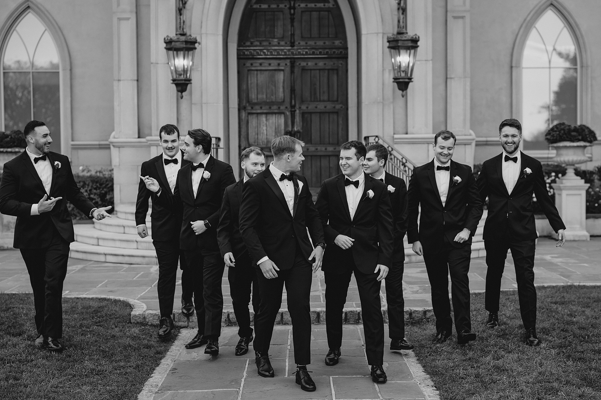groom walks with groomsmen outside Park Chateau chapel 
