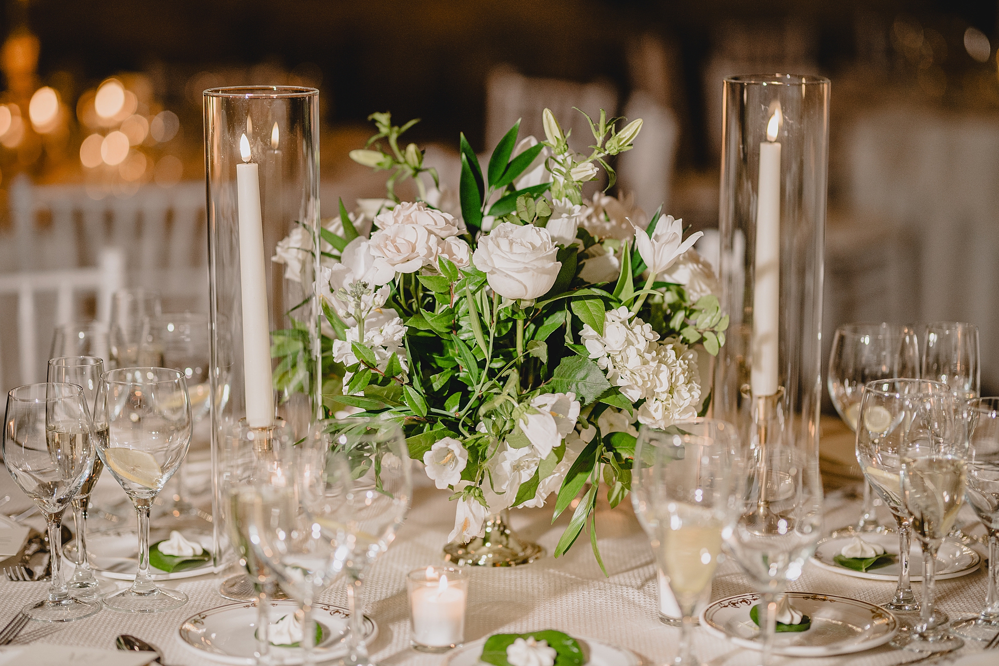 wedding reception with white rose centerpieces and taper candles at Park Chateau Estate