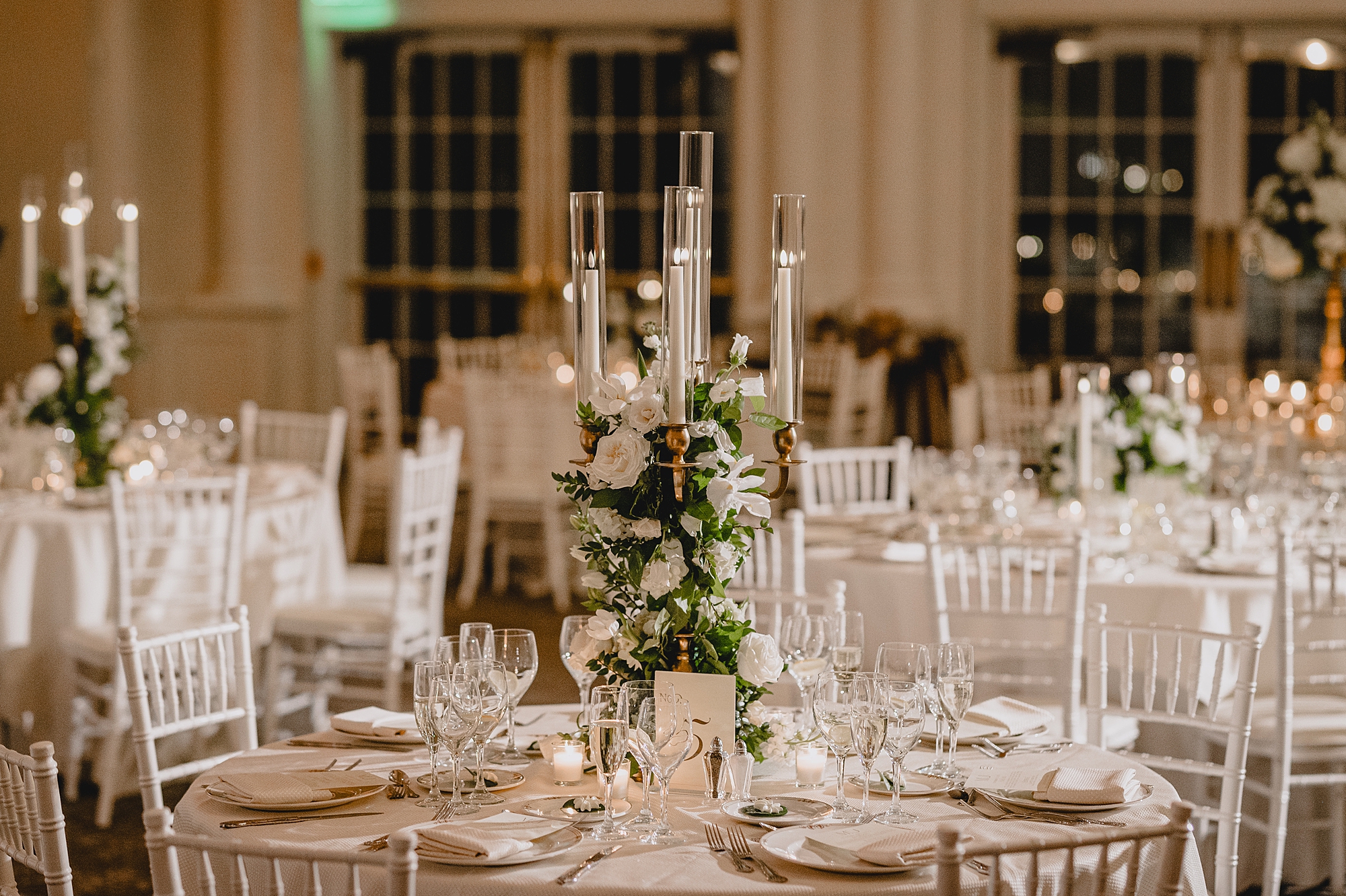 centerpieces for fall wedding reception at Park Chateau Estate with white chairs, tables, and flowers 