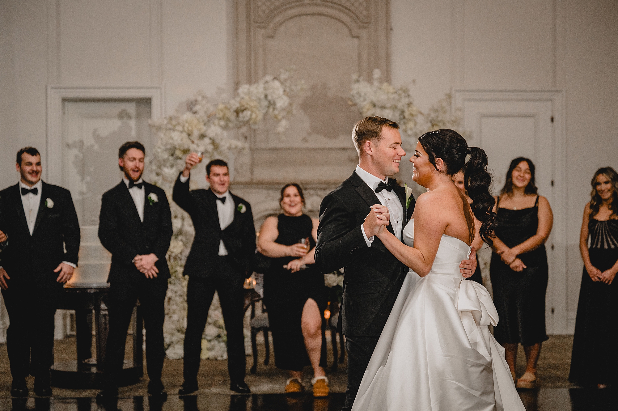 groom grins at bride during first dance in New Jersey