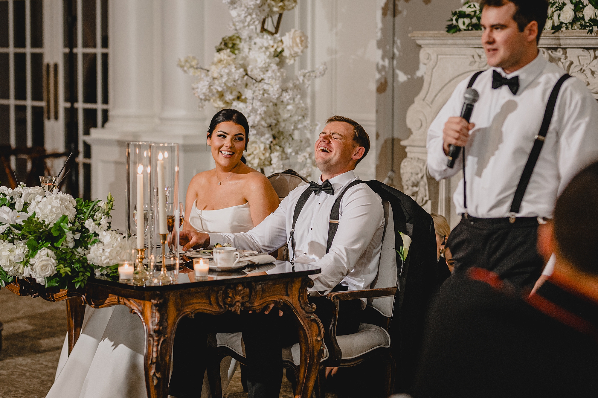 groom throws head back during reception at Park Chateau Estate
