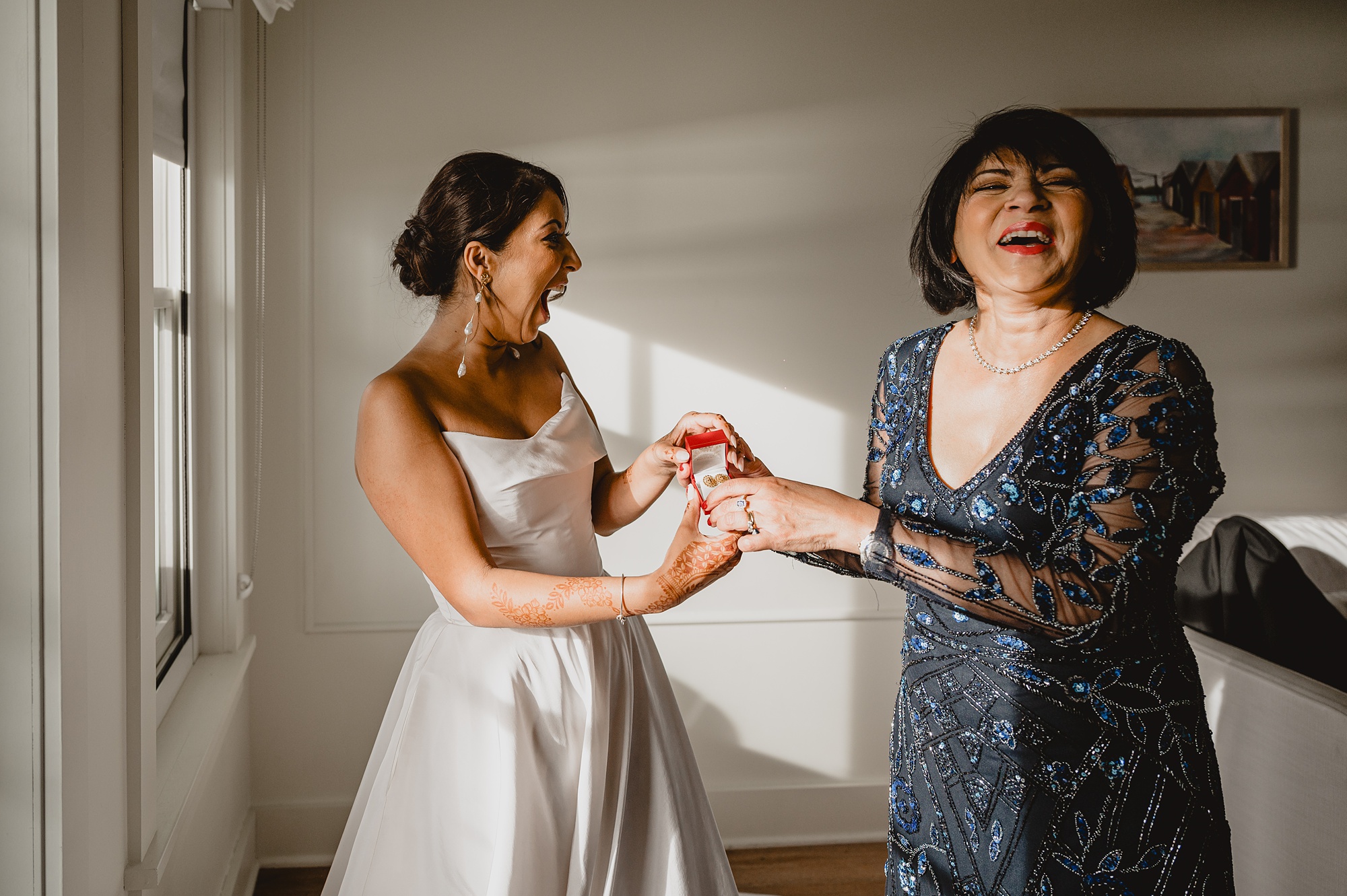 mother laughs with bride on morning of wedding at the Lake House at Canandaigua