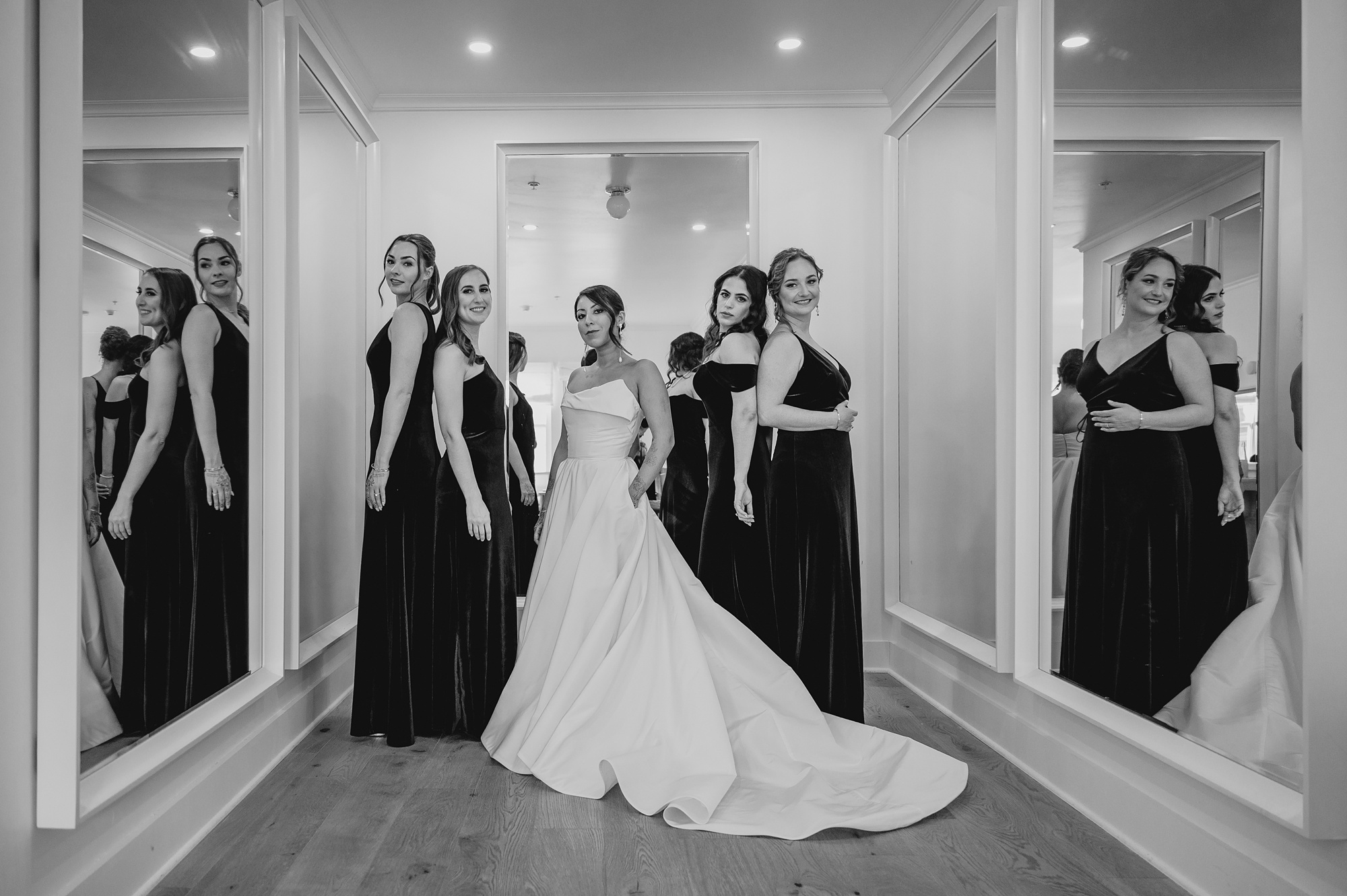 bridesmaids pose with bride in hallway at the Lake House at Canandaigua
