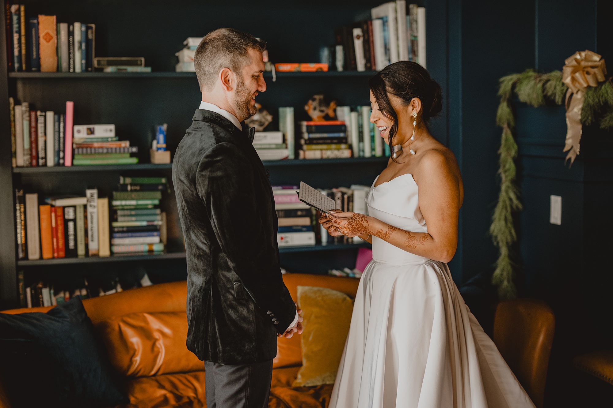 bride and groom read vows in library at the Lake House at Canandaigua