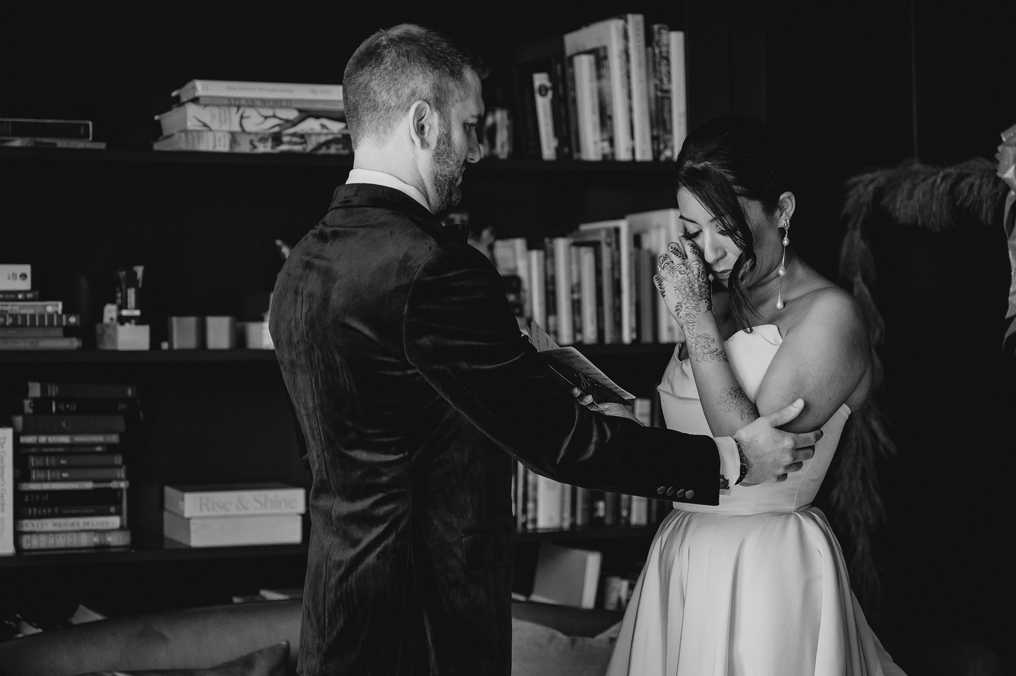 bride and groom read vows in library at the Lake House at Canandaigua