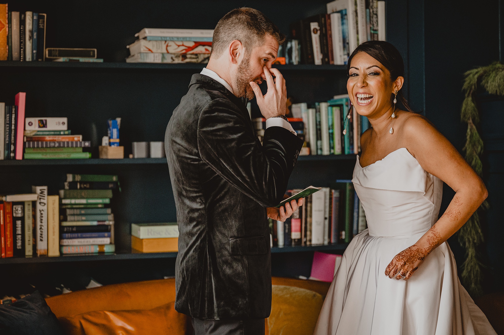 bride and groom read vows in library at the Lake House at Canandaigua