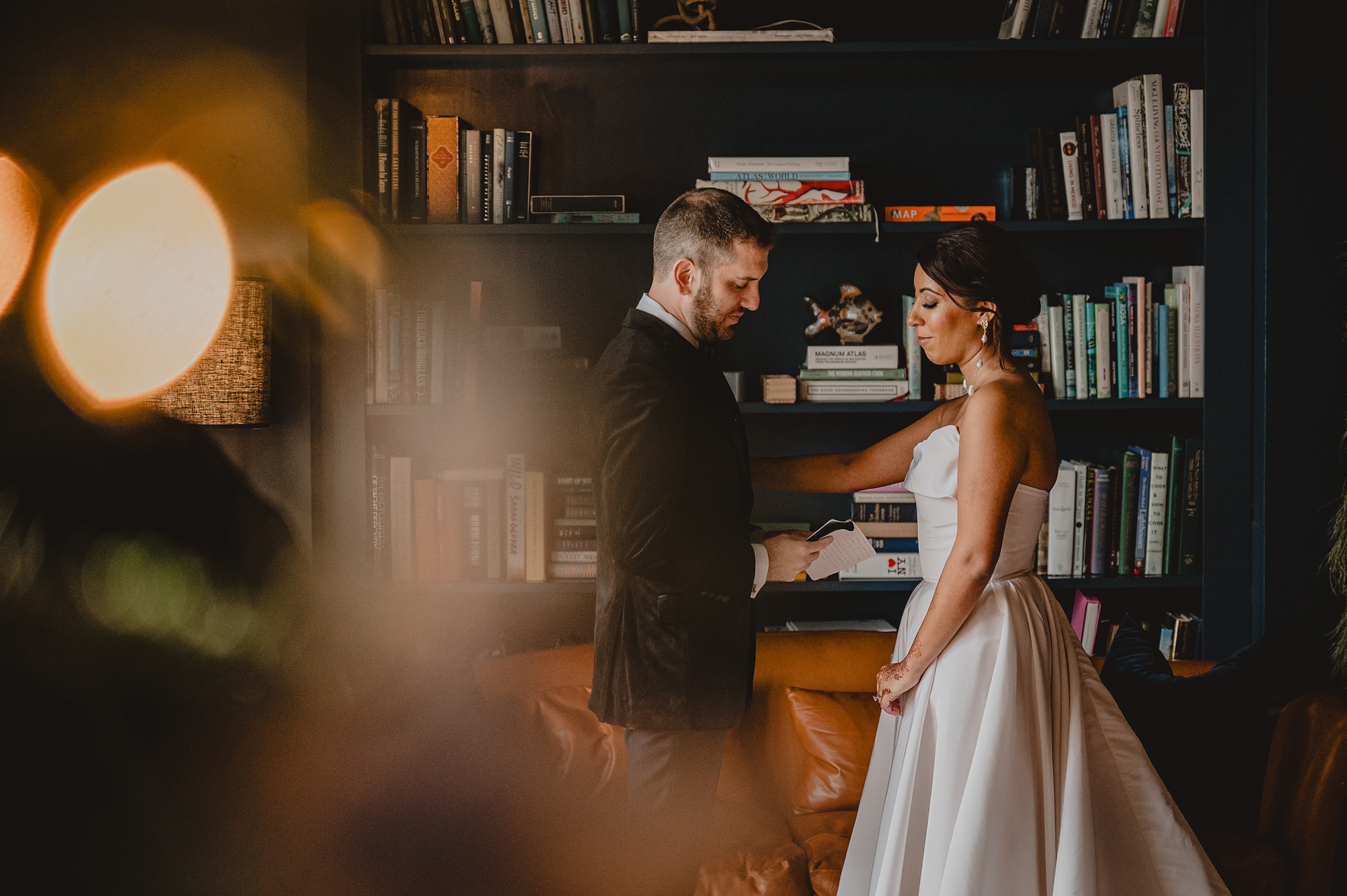 bride and groom read vows in library at the Lake House at Canandaigua
