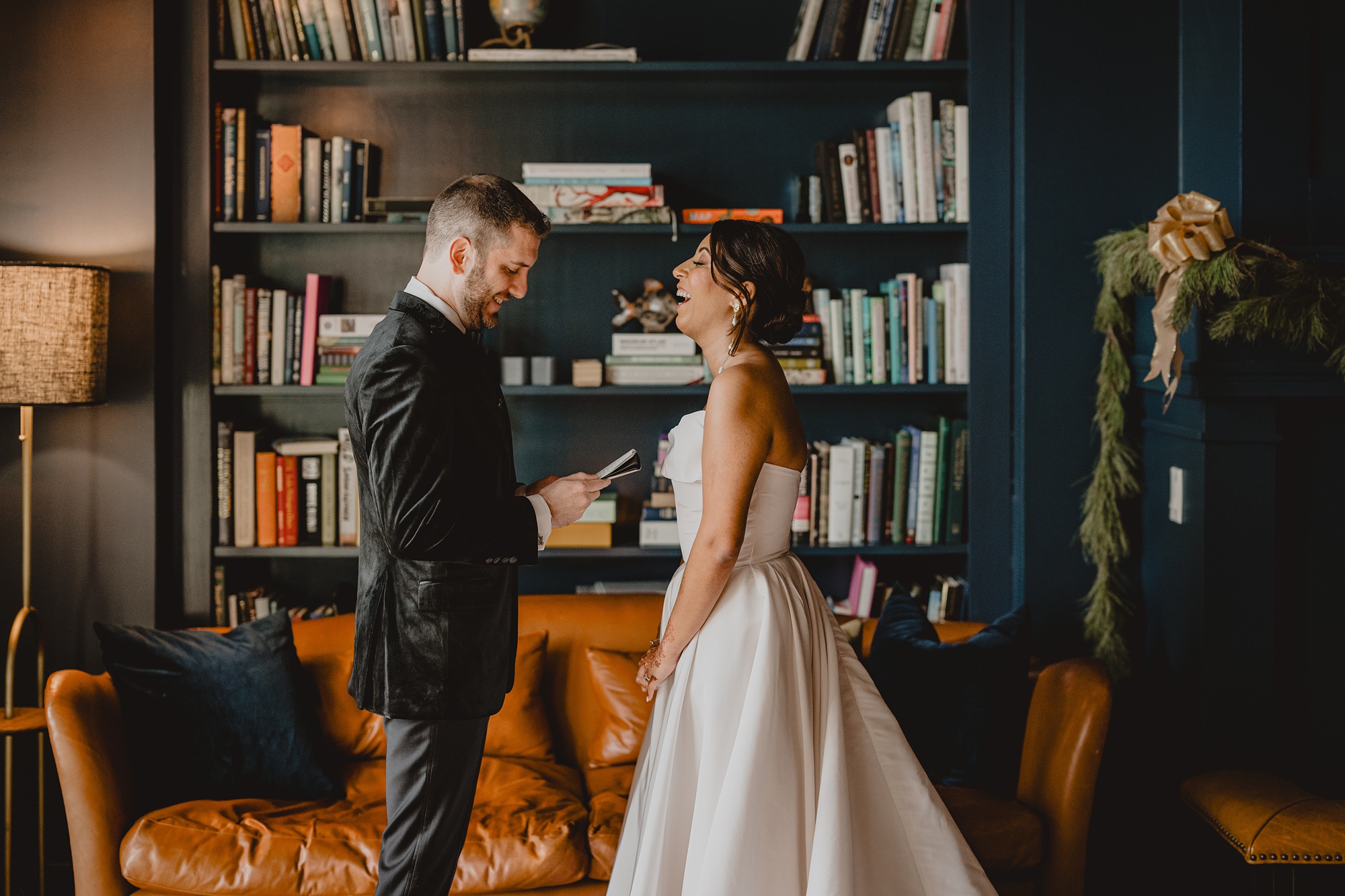 bride and groom read vows in library at the Lake House at Canandaigua