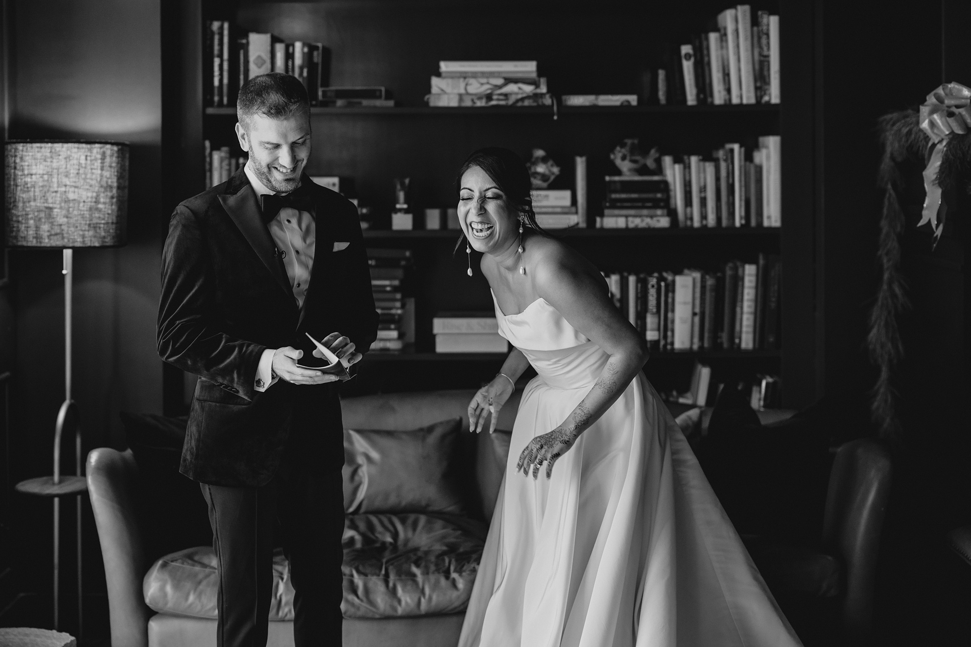 bride and groom read vows in library at the Lake House at Canandaigua