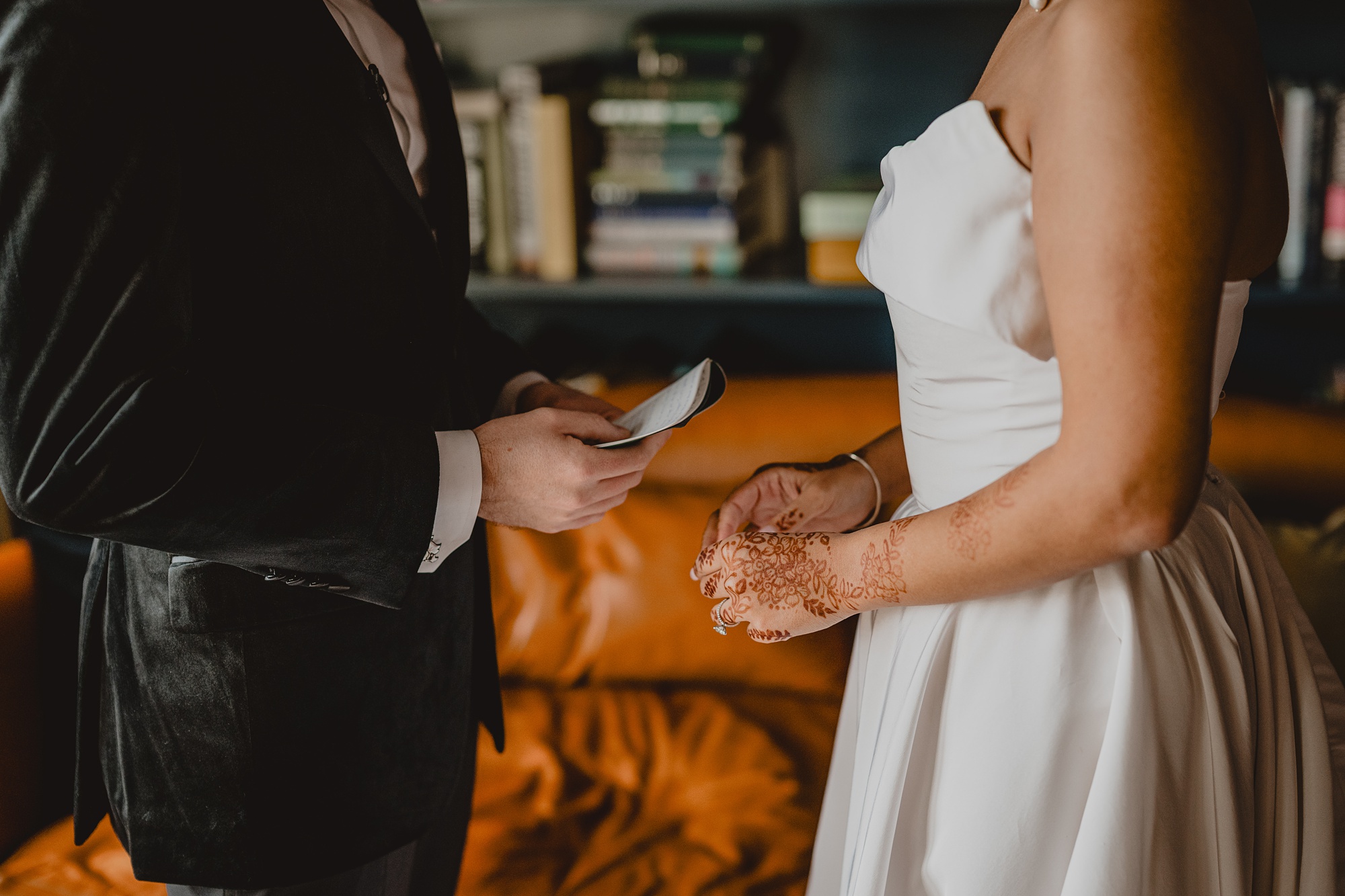 bride and groom read vows in library at the Lake House at Canandaigua