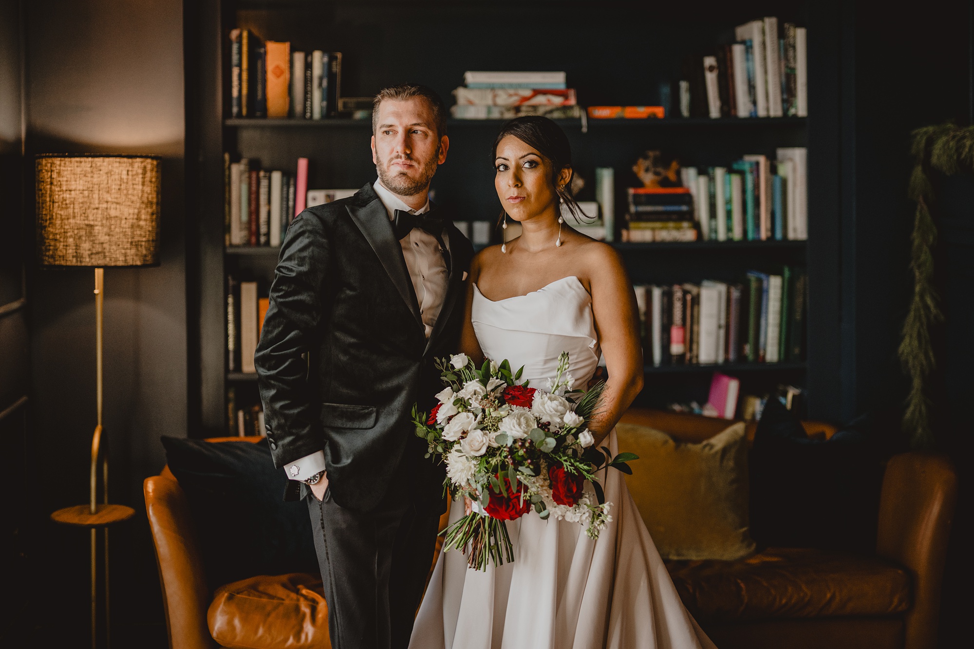 bride and groom hug standing in the library at the Lake House at Canandaigua