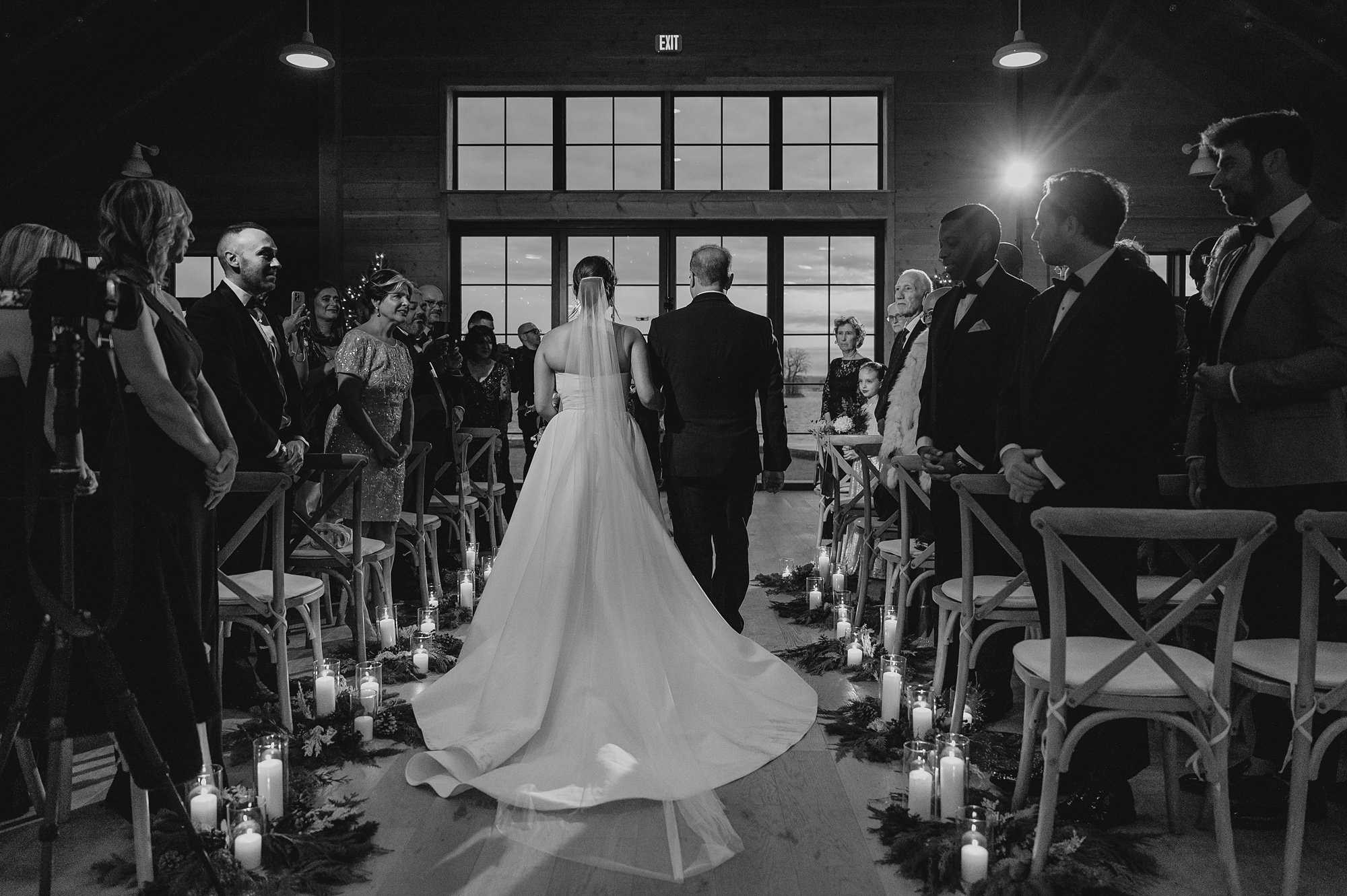 father escorts bride down the aisle lined with candles at the Lake House at Canandaigua
