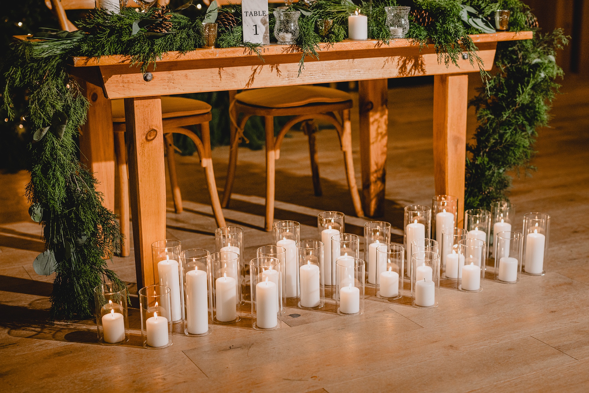 candles sit in front of wooden table for bride and groom at the Lake House at Canandaigua