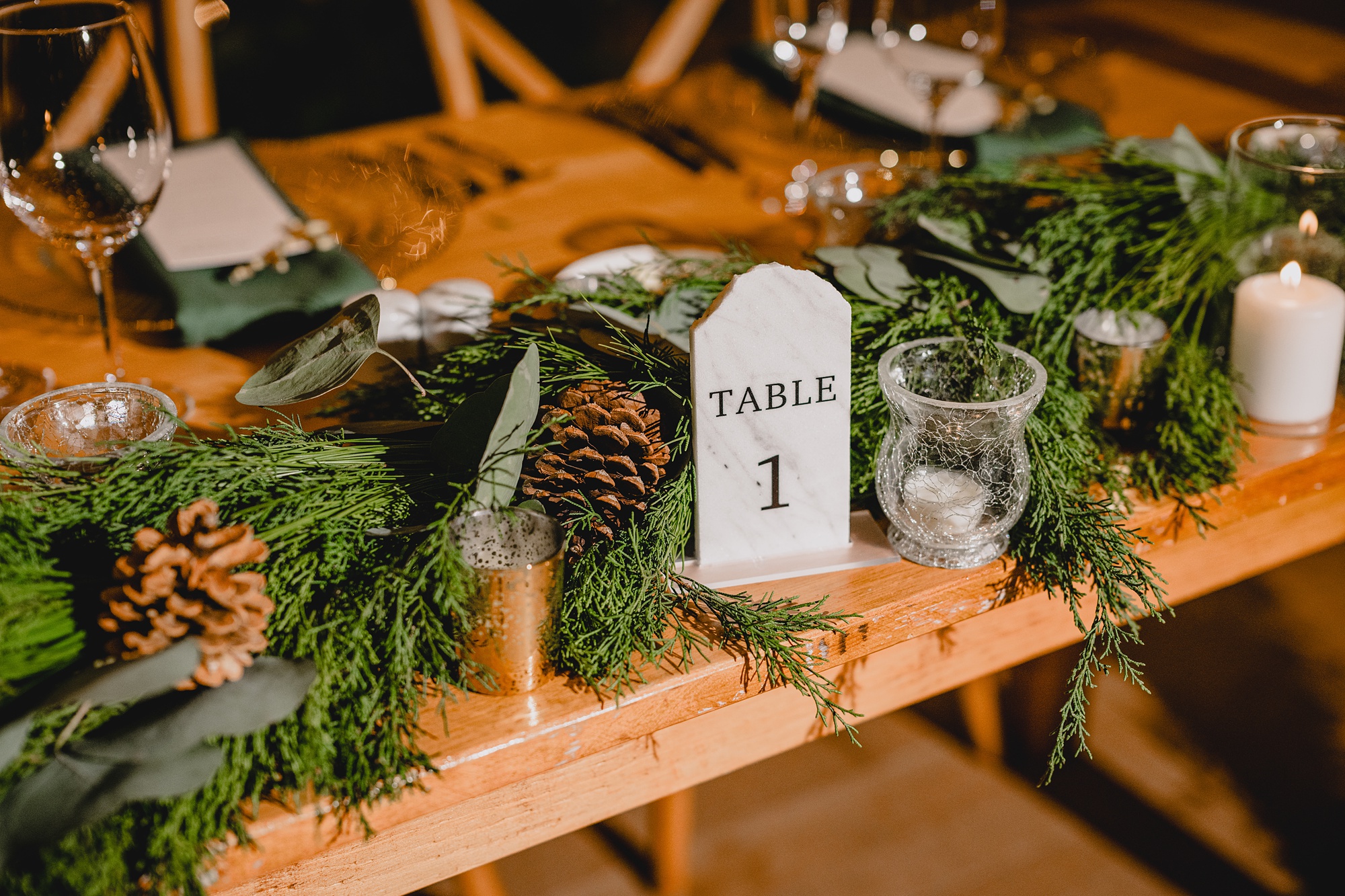 table with runner of greenery and pinecones at the Lake House at Canandaigua