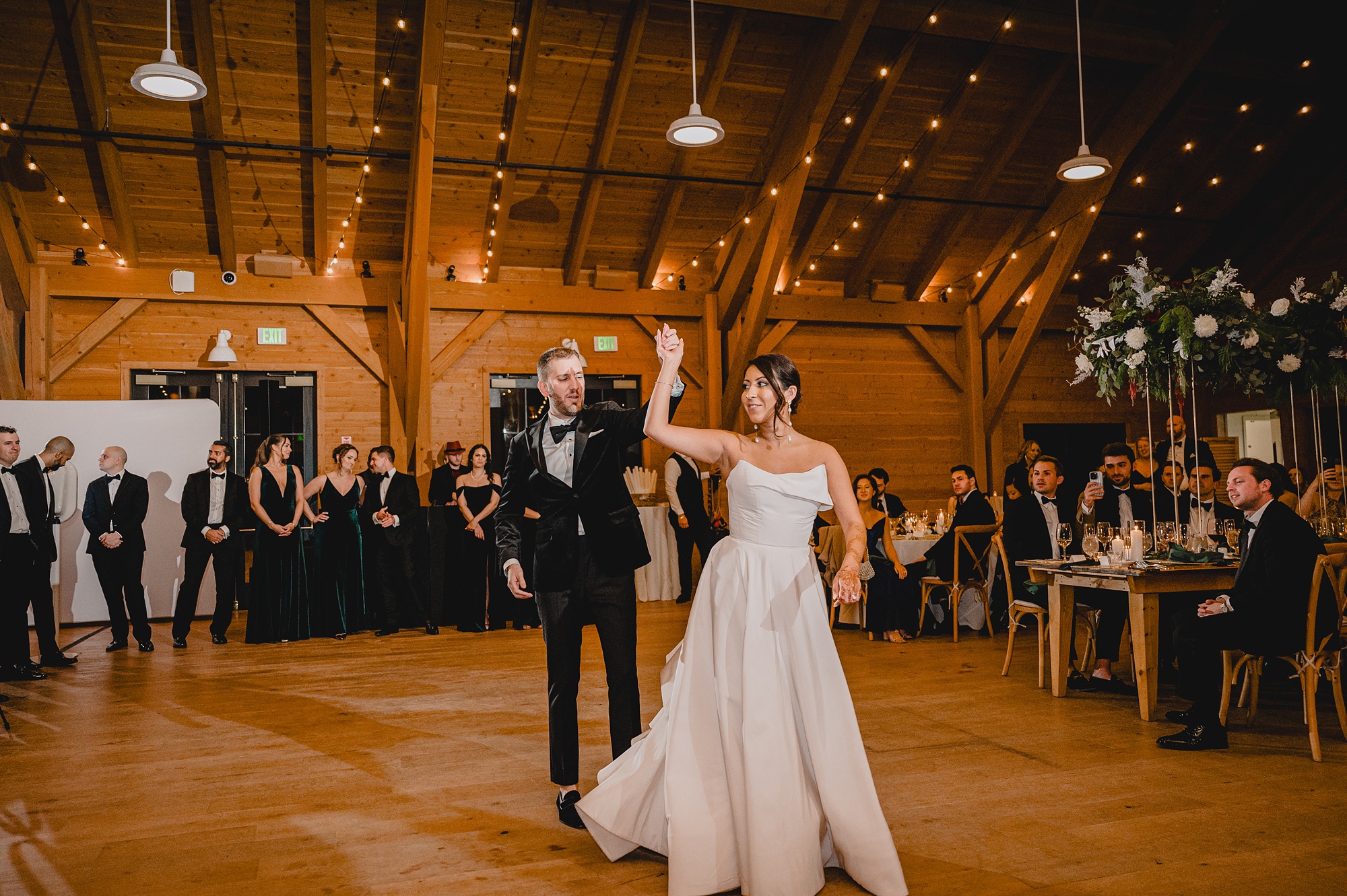 groom twirls bride during wedding reception at the Lake House at Canandaigua