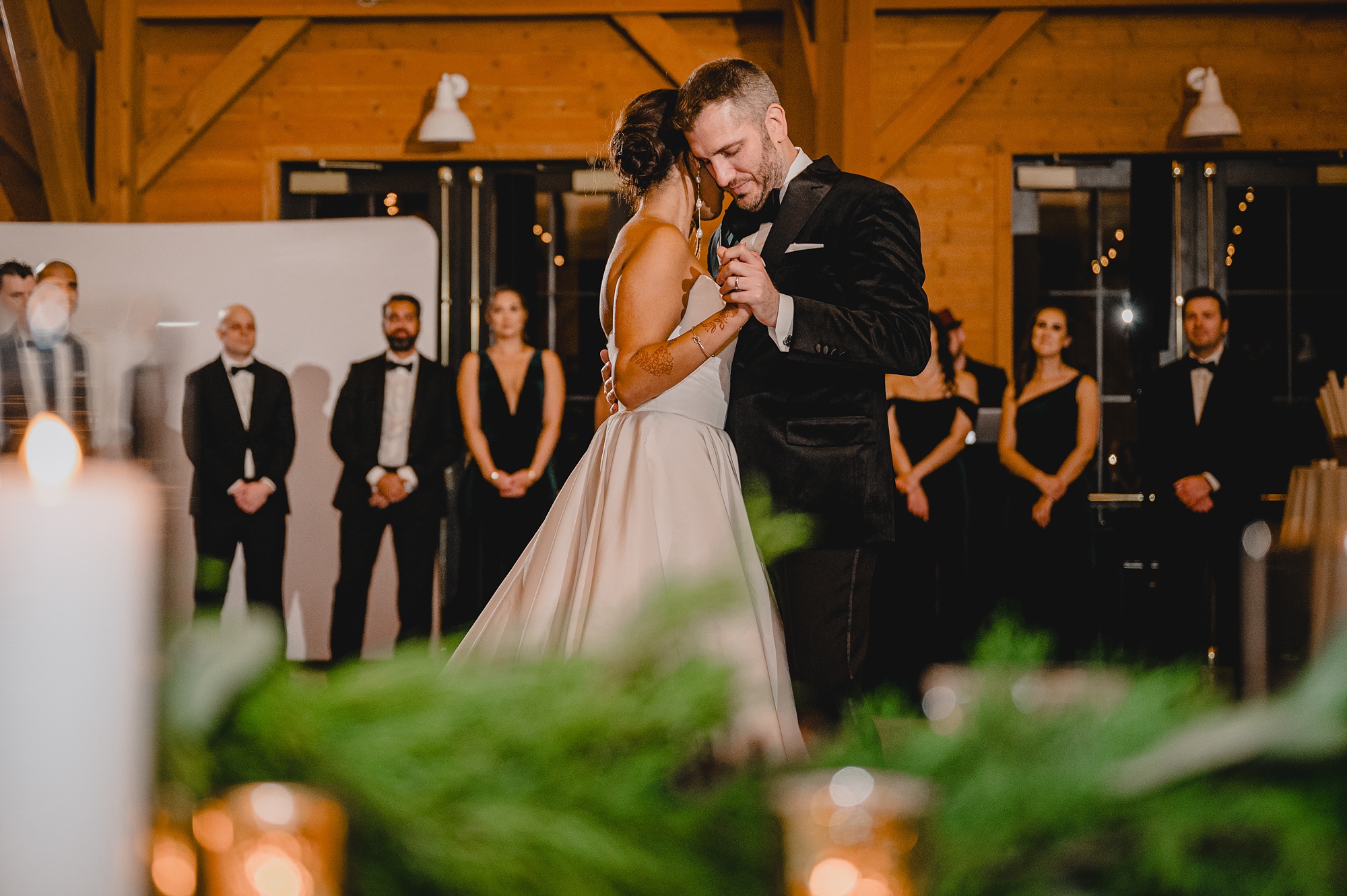 bride hugs groom to her during wedding reception dance 