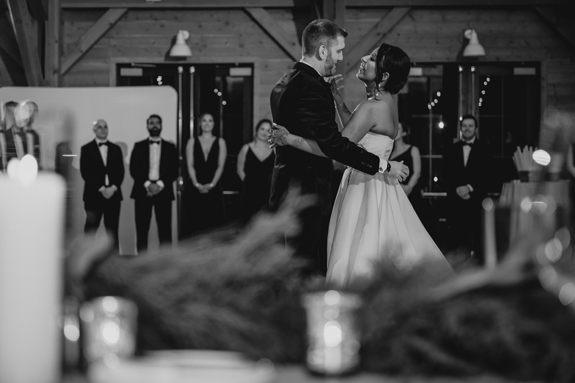 groom hugs bride around waist on dance floor at the Lake House at Canandaigua