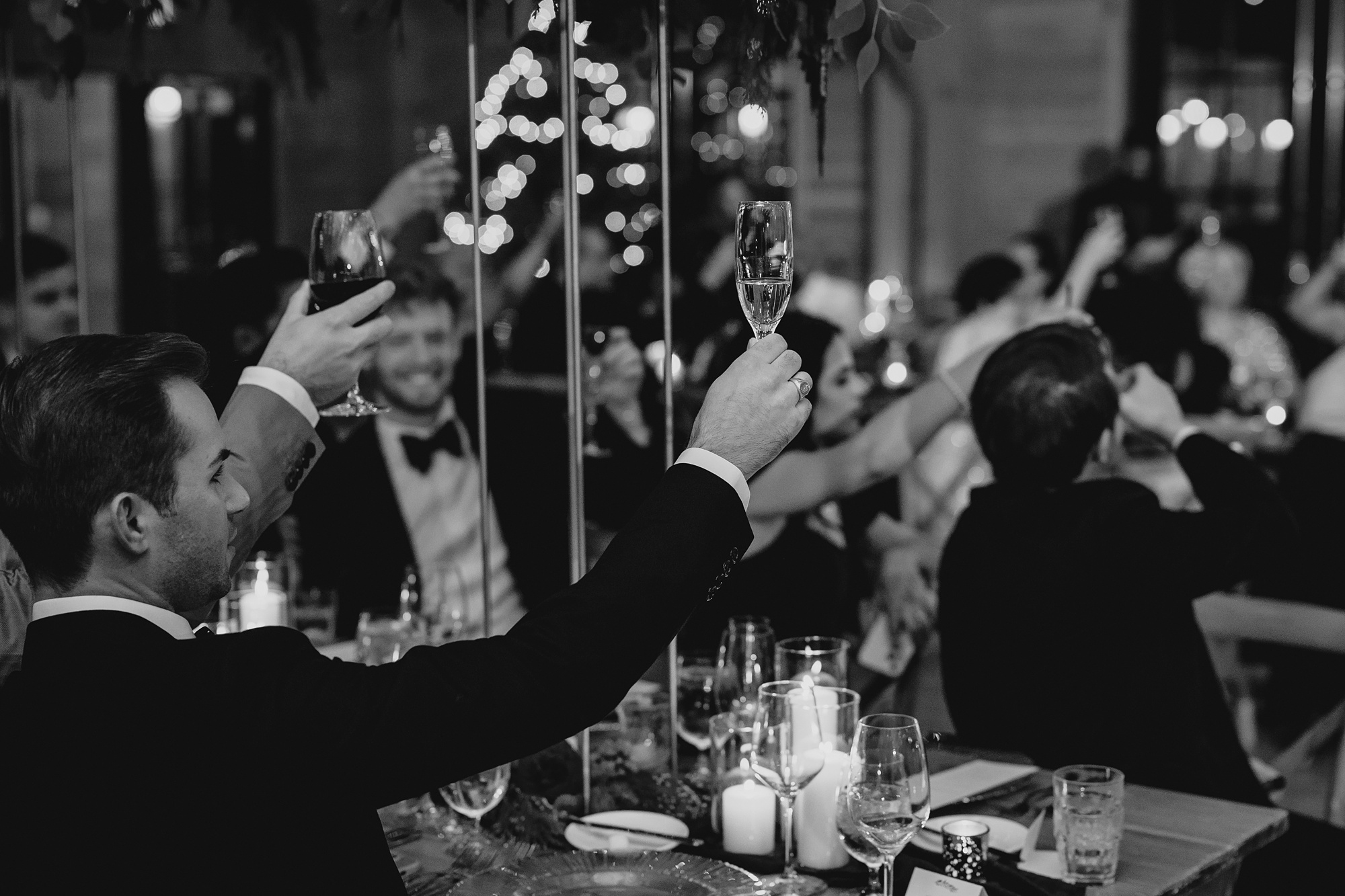 guests lift drinks in toast during winter wedding reception in New Jersey