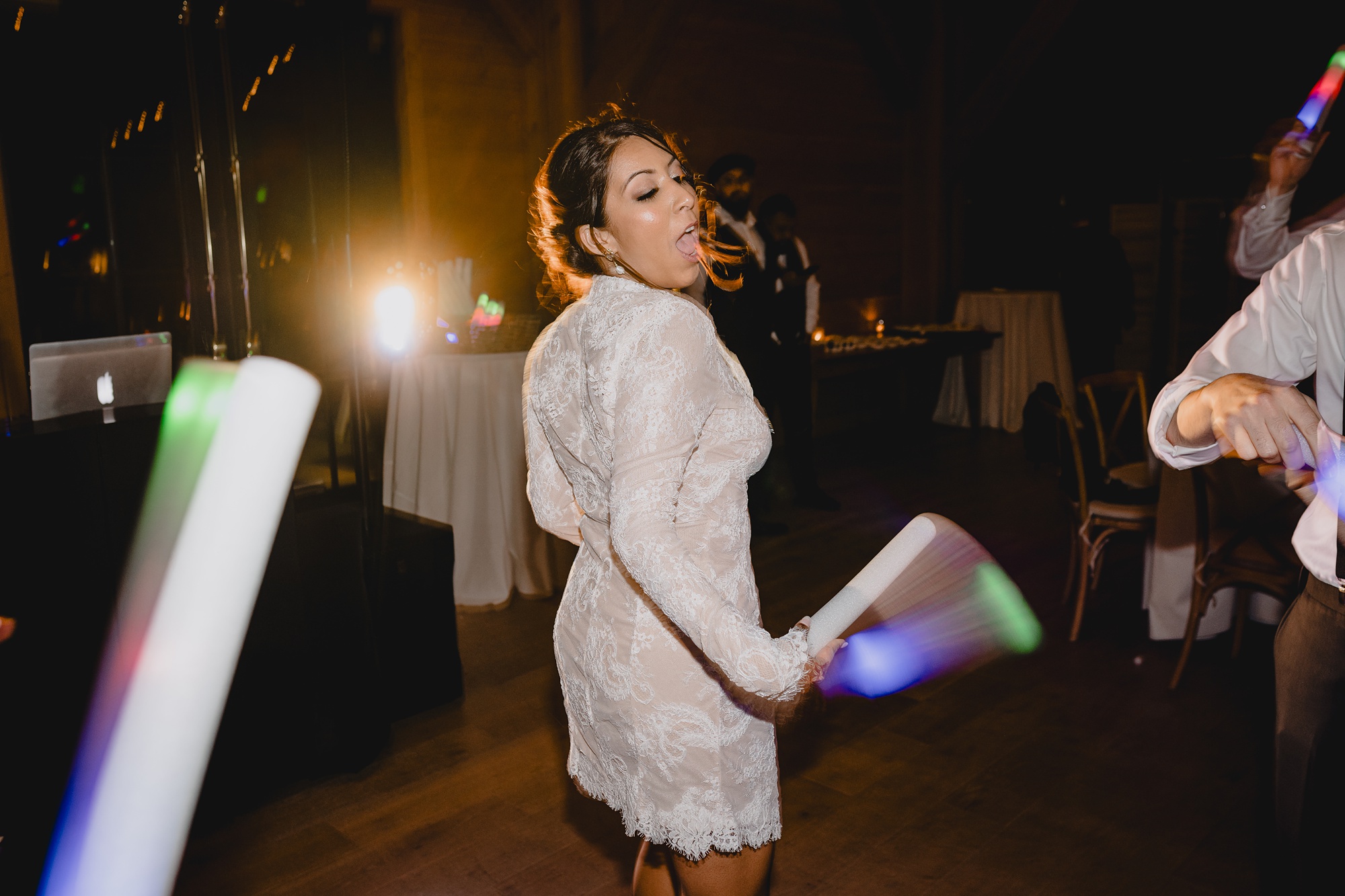 bride dances in short lace dress during winter wedding reception in New Jersey