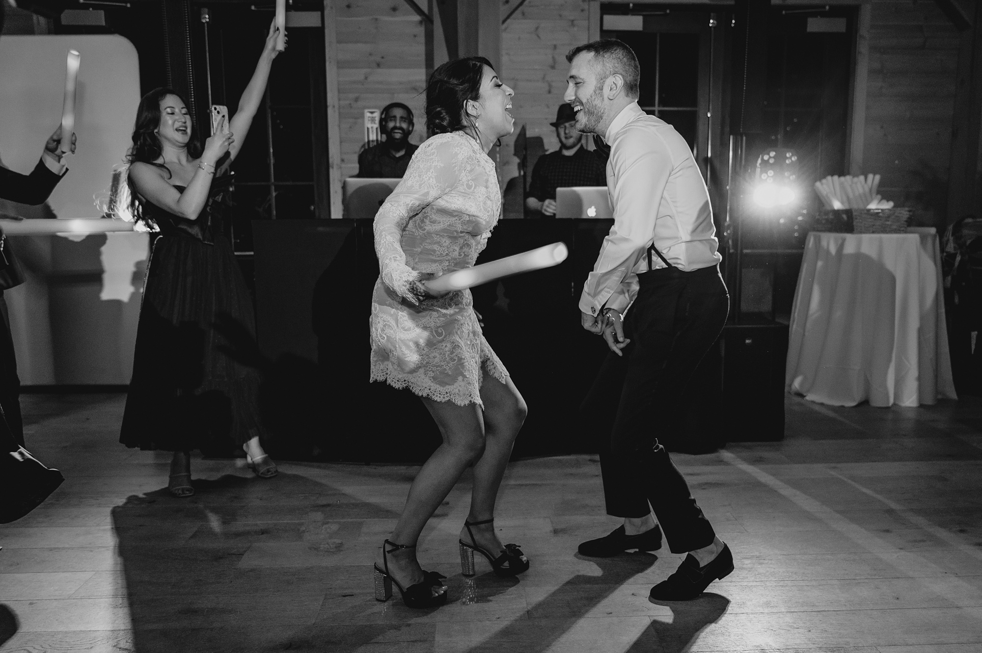 bride and groom dance and sing during winter wedding reception in New Jersey
