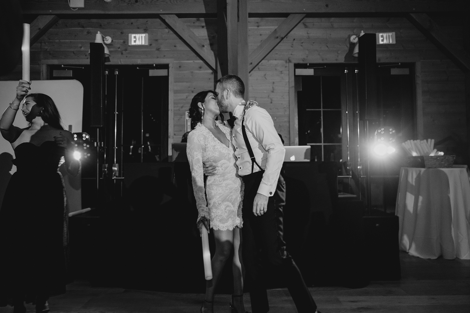 newlyweds kiss on dance floor during winter wedding reception in New Jersey