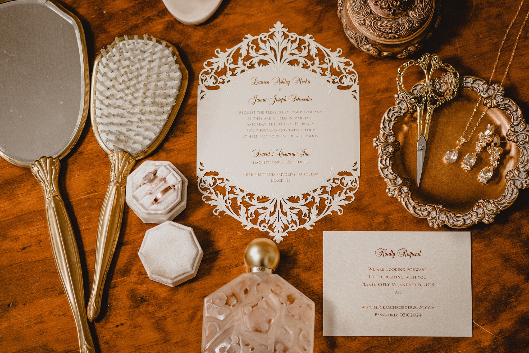 winter invitation suite with delicate cutouts and bride's jewelry and details