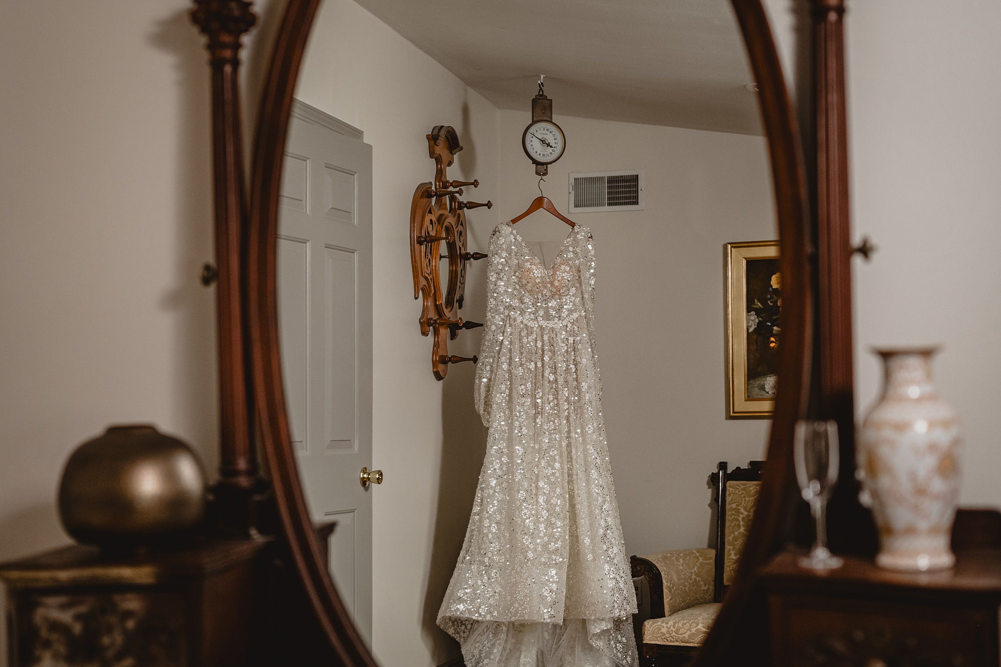long sleeve wedding gown hangs in room at David's Country Inn