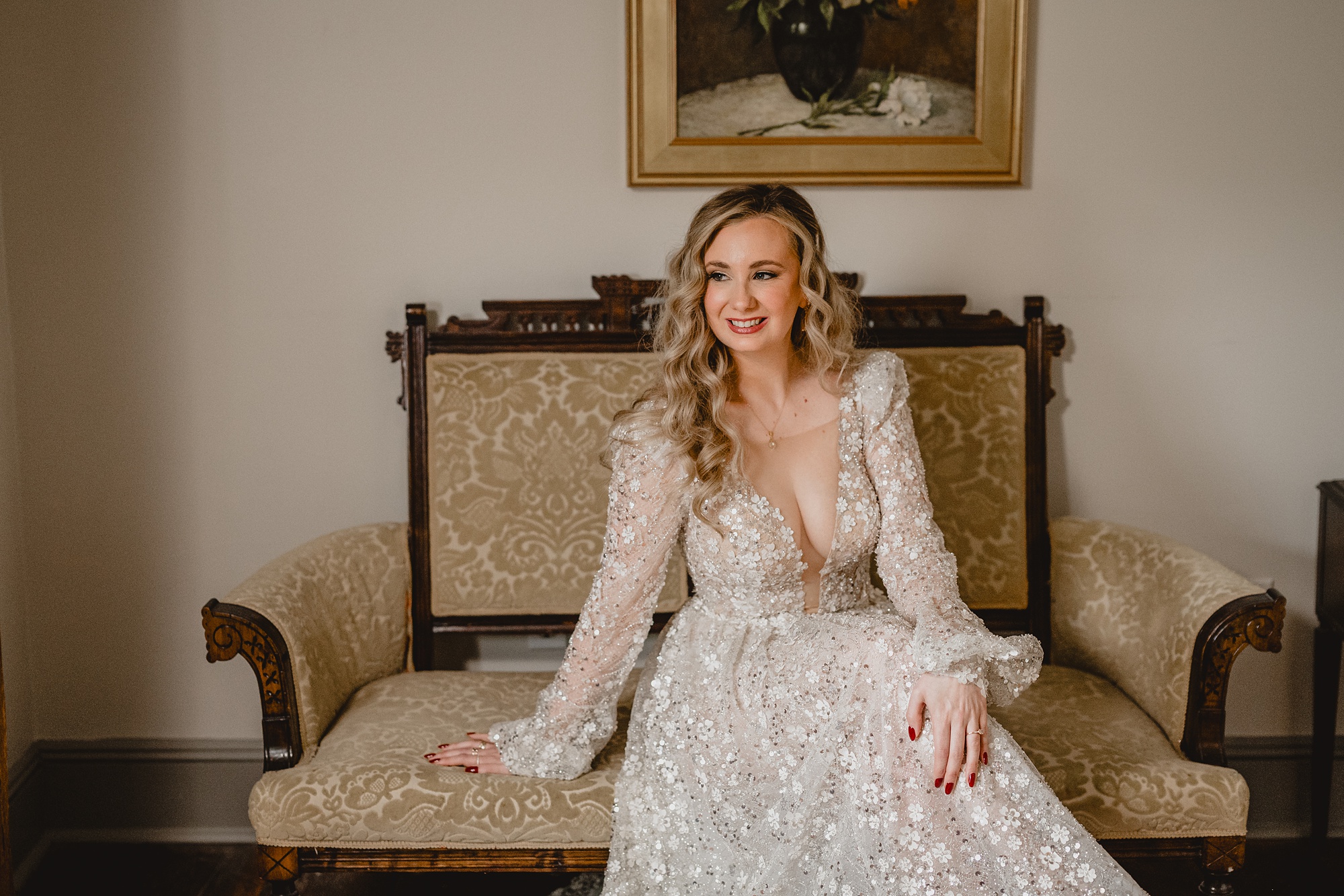 bride sits on vintage wooden chair inside suite at David's Country Inn