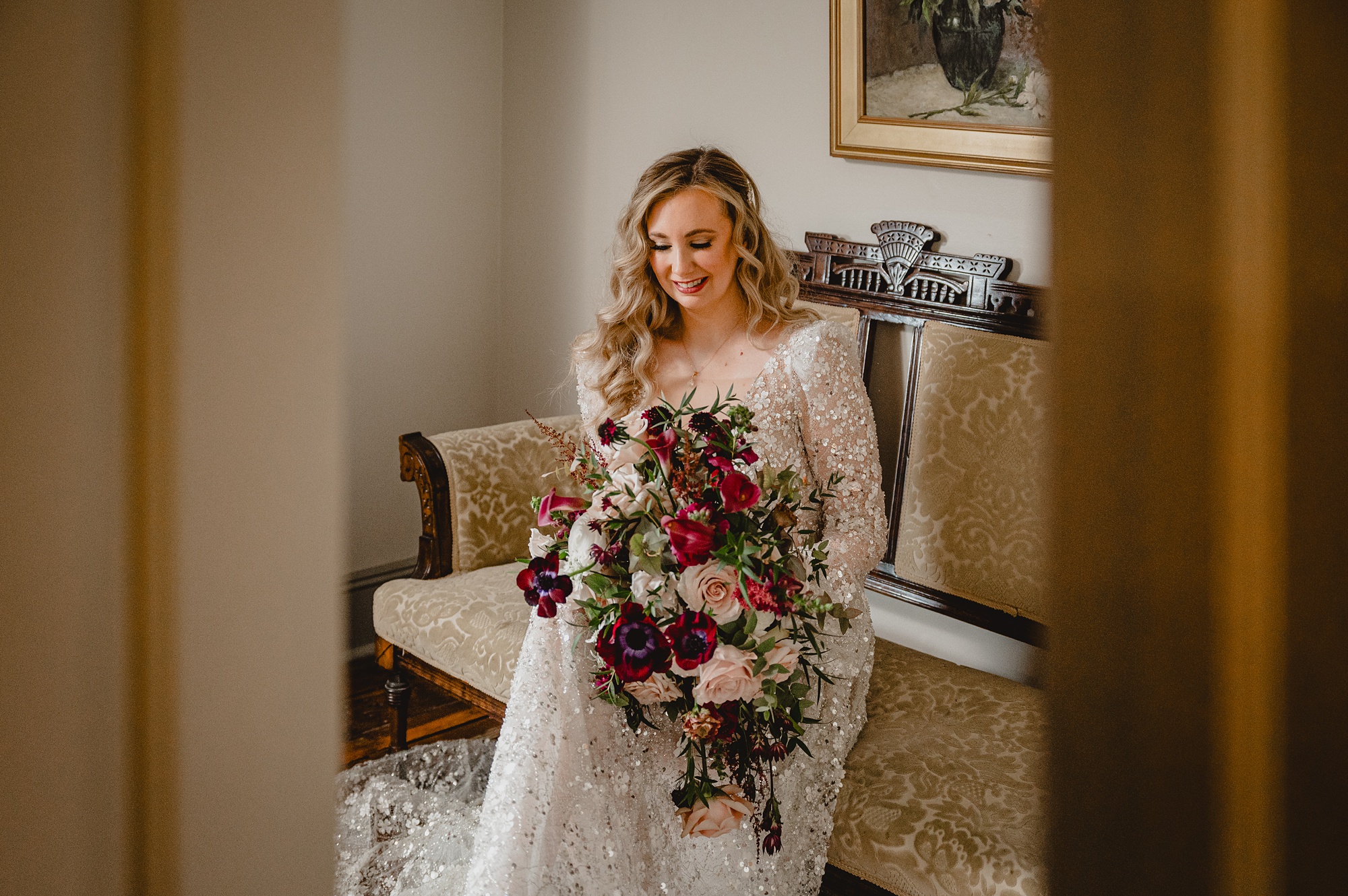 brie looks down at winter bouquet sitting on gold and wooden chair at David's Country Inn