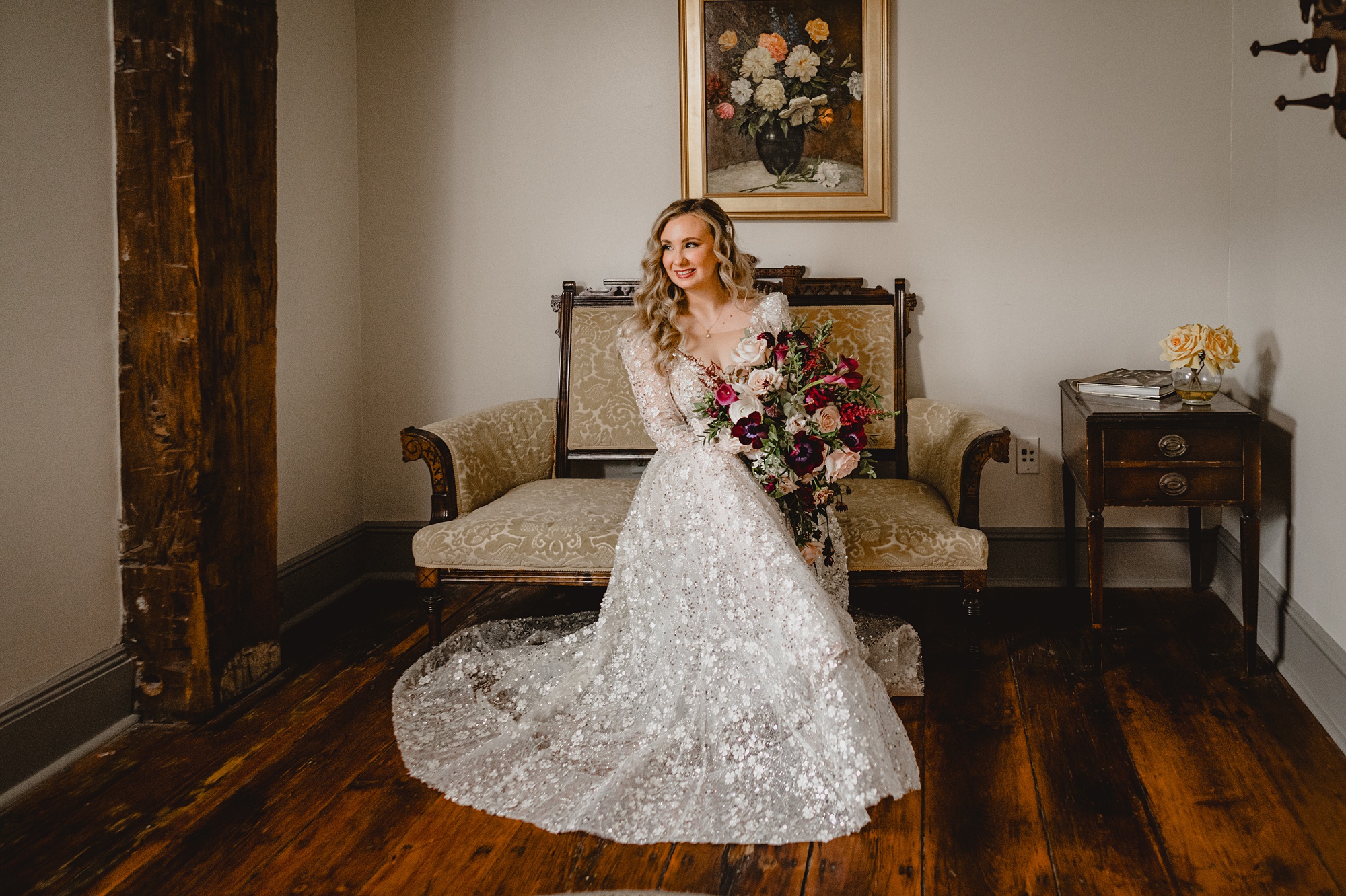 bride sits on vintage chair inside suite at David's Country Inn