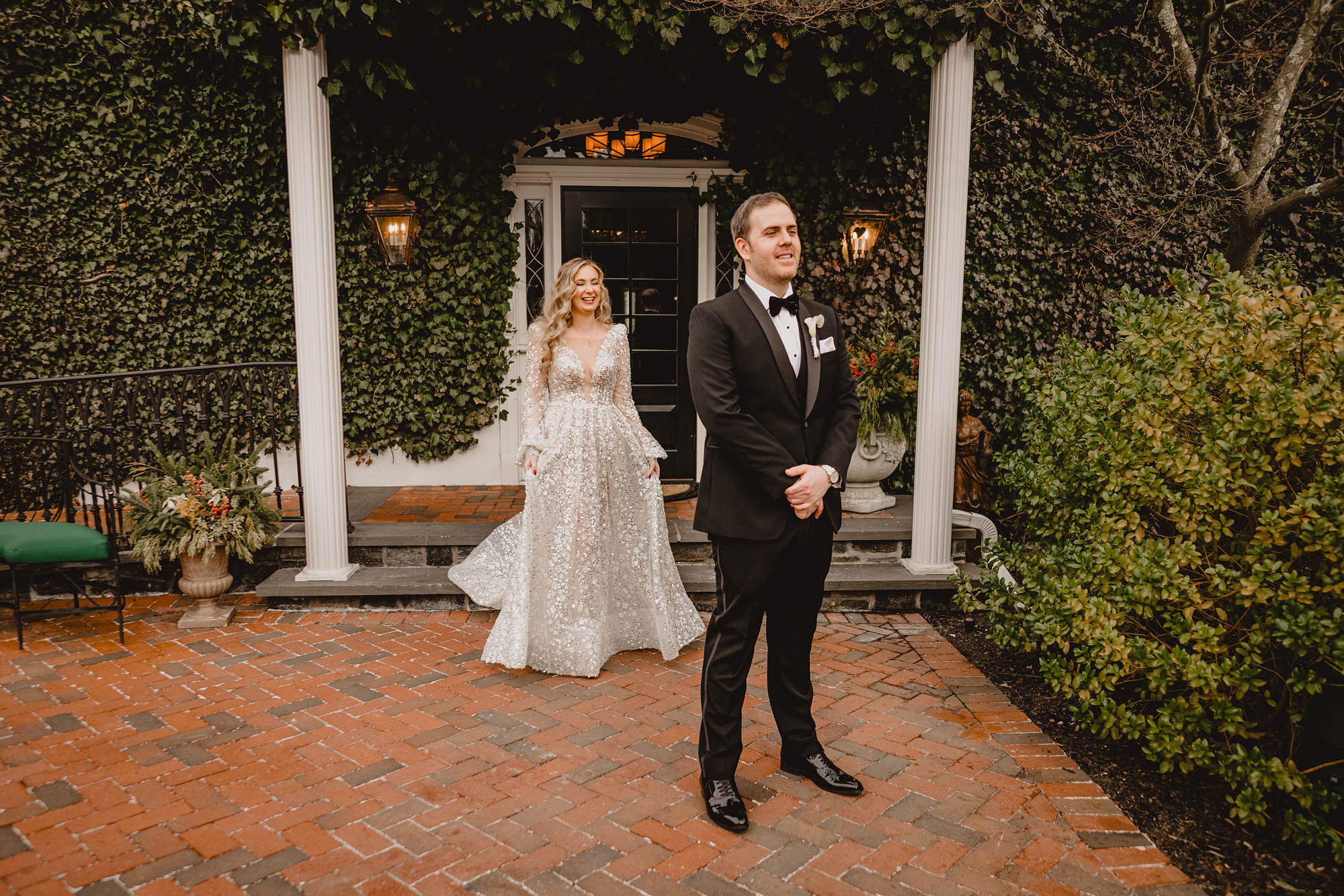 bride approaches groom for first look on patio at David's Country Inn