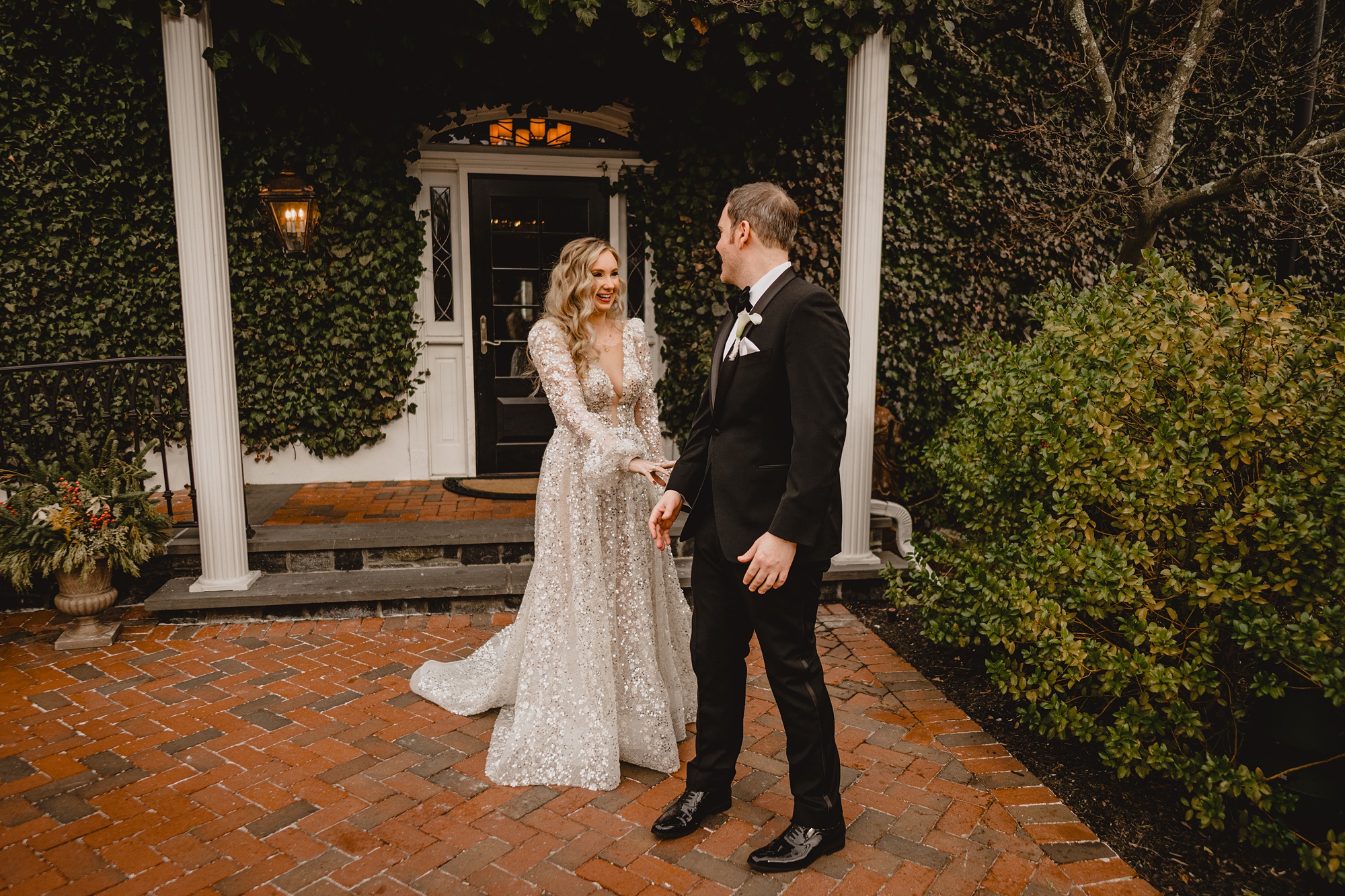 groom turns to look at bride on patio during first look