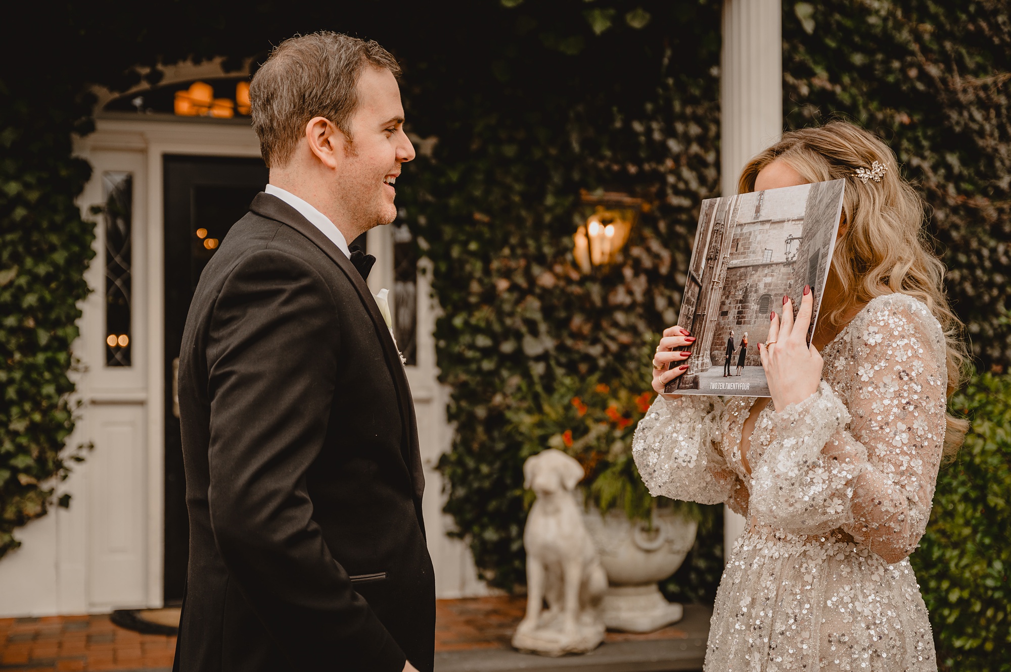 bride holds a record up in front of her face looking at the groom