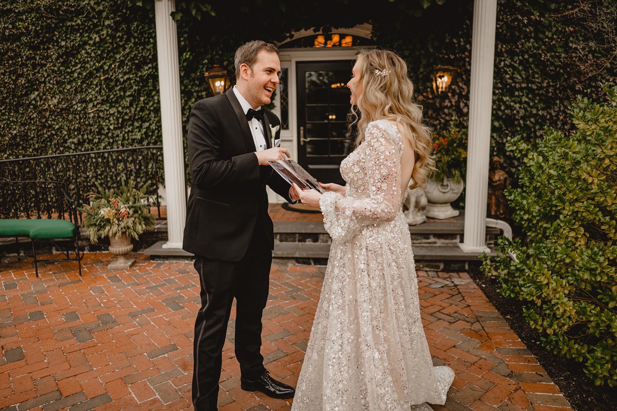 bride and groom laugh standing on brick patio at David's Country Inn