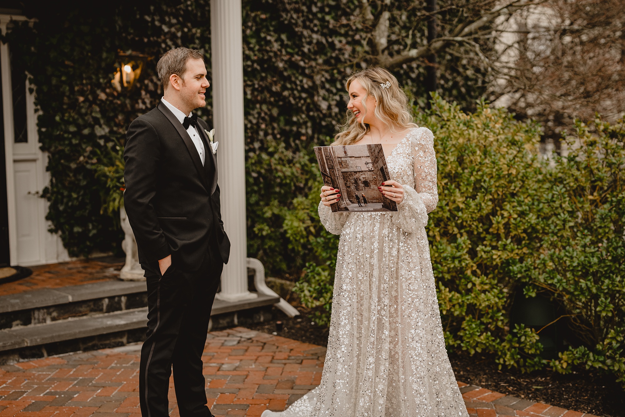 groom looks at bride holding record