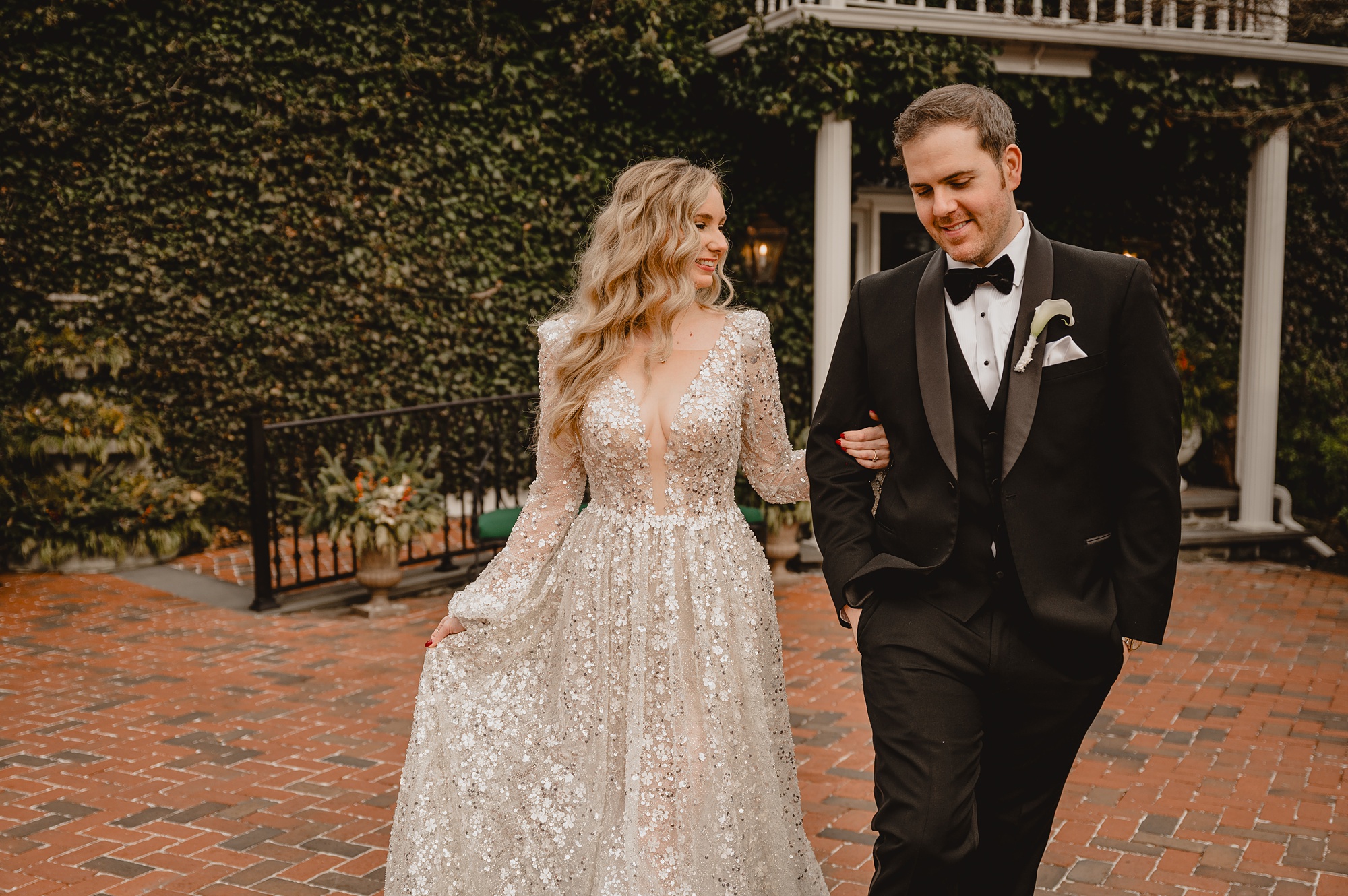 newlyweds smile walking arm in arm at David's Country Inn