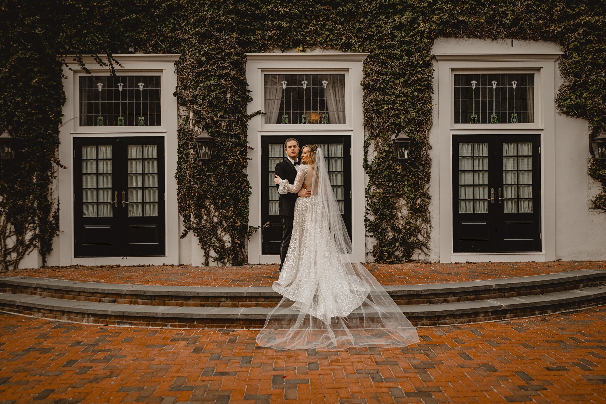 bride and groom stand on brick steps at David's Country Inn