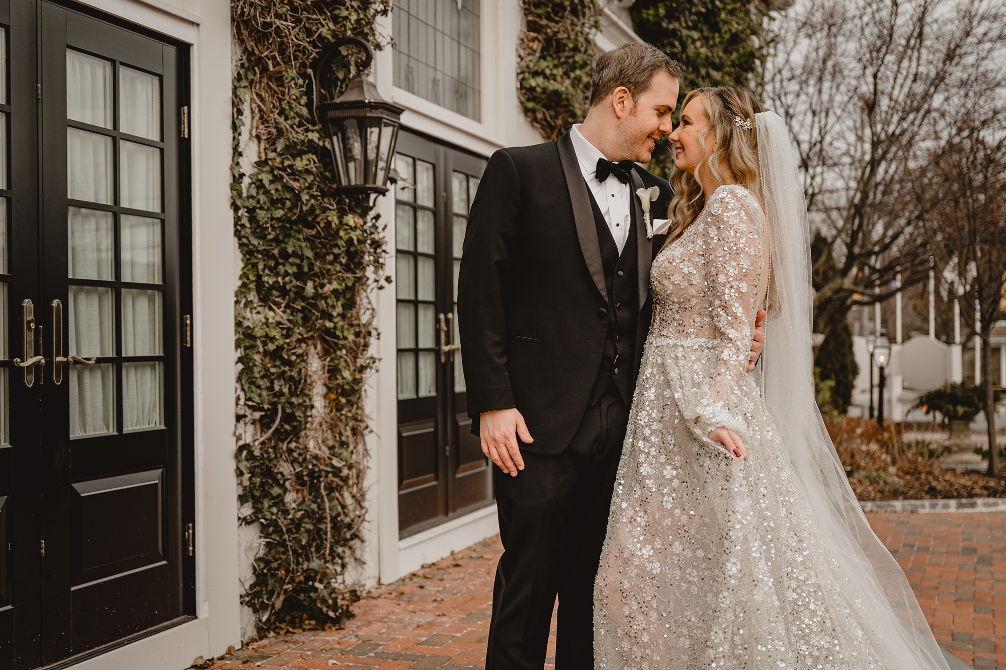 bride and groom hug smiling at each other and touching noses