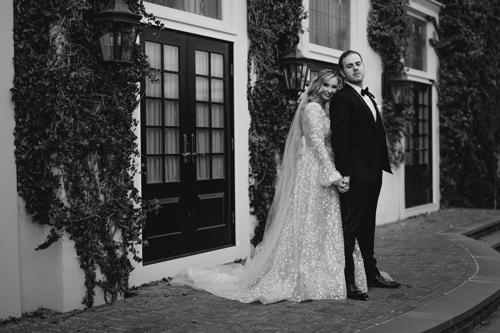bride and groom hold hands standing together at David's Country Inn