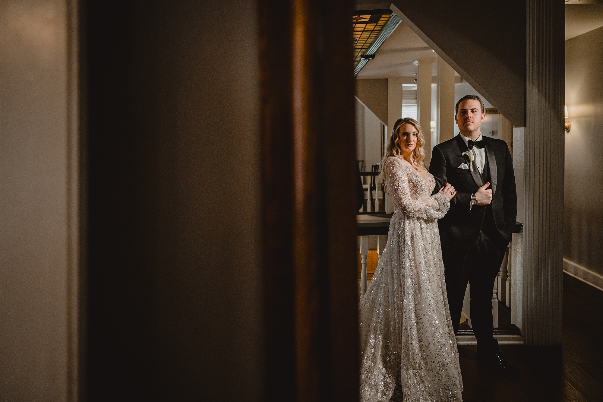 newlyweds pose near stained glass at David's Country Inn